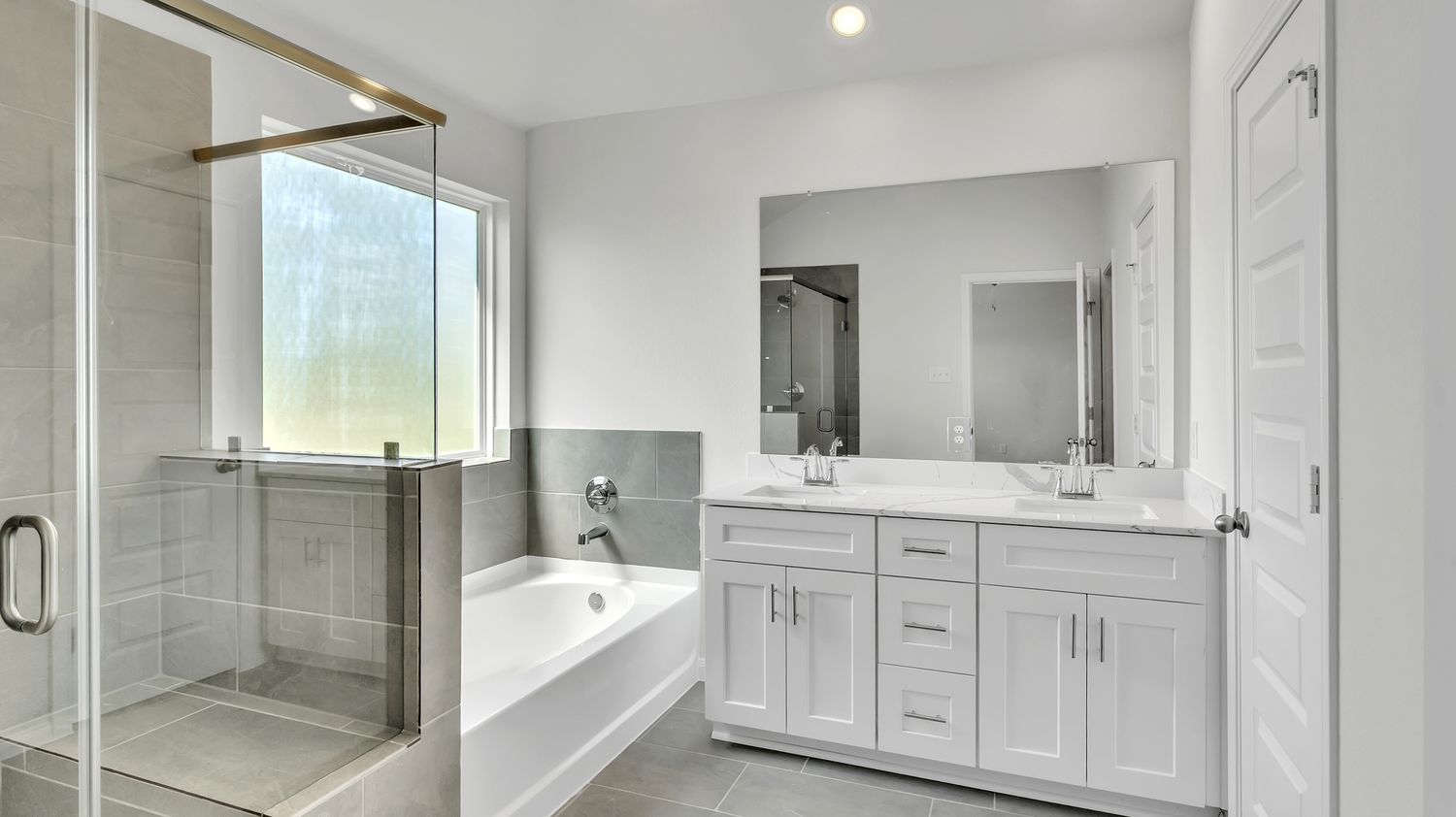 Modern white bathroom with linear layout featuring double vanity, glass shower enclosure and contemporary fixtures.