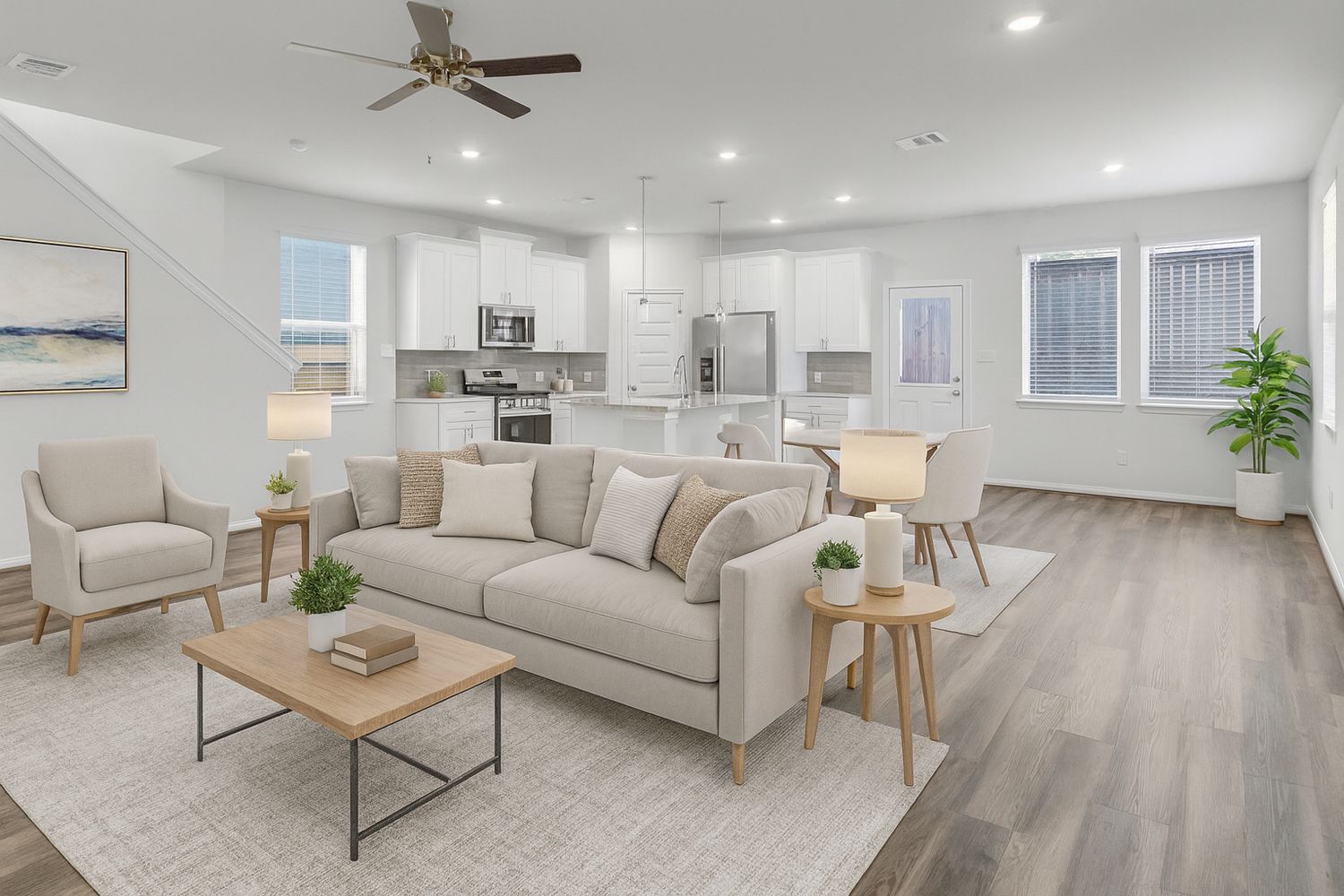 Modern living room with recessed lighting, ceiling fan, and light gray hardwood floors throughout.