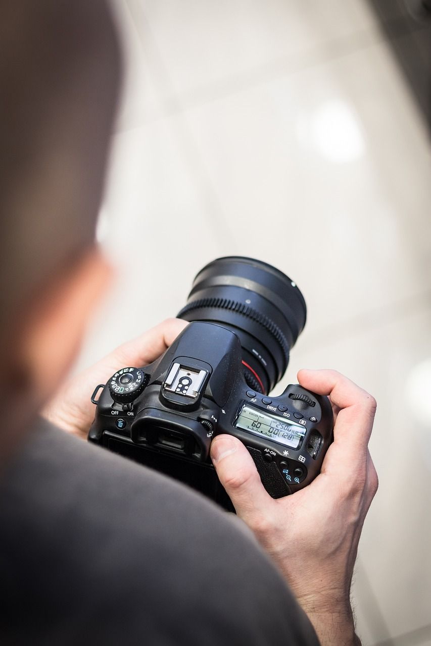Photographer capturing interior shots of a home in Houston with professional camera gear.Behind the scenes of a real estate photo shoot in H