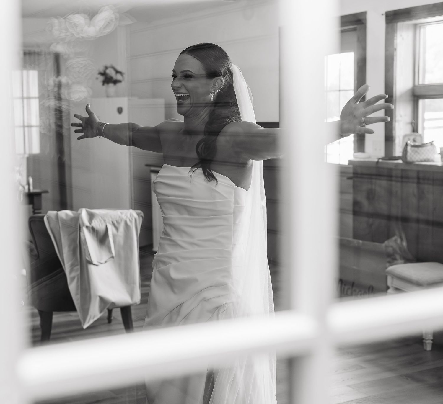 Bride showing her bridesmaids her final look