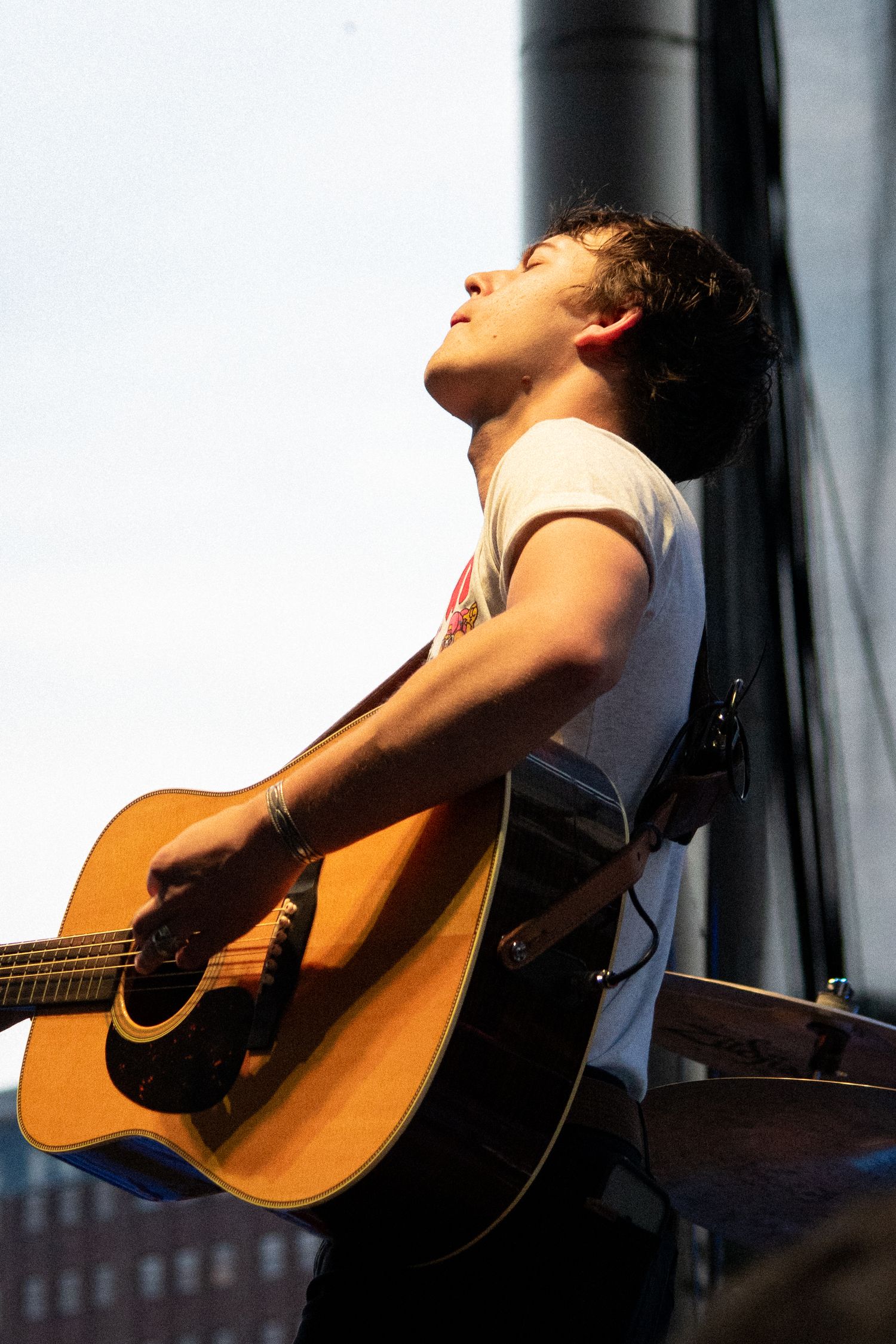 Musician playing guitar on stage during a live show