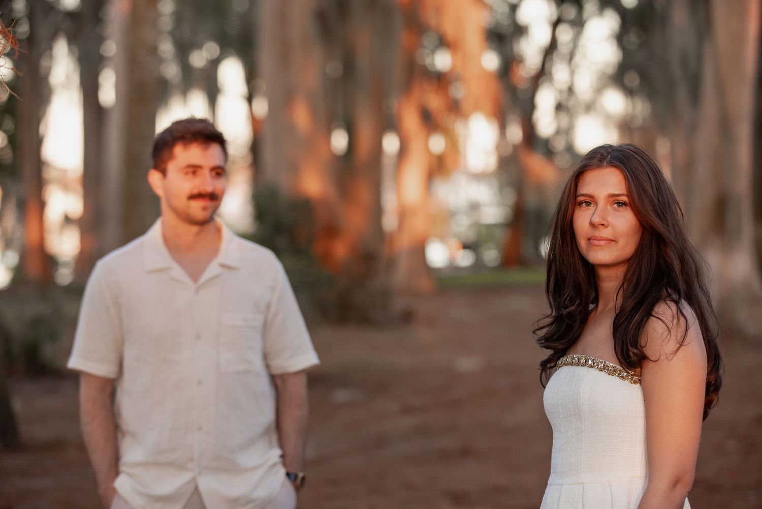 Engagement photos of a couple walking through Kraft Azalea Garden in Winter Park.