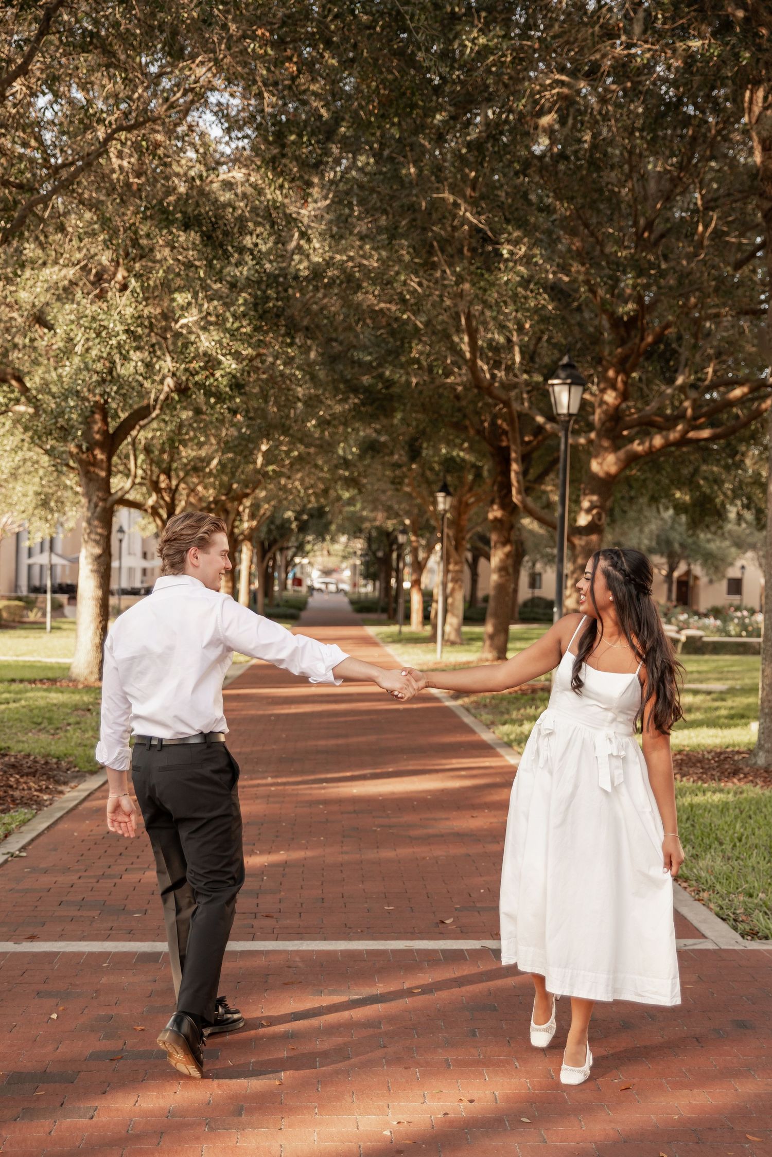 Engaged couple walking together on the Rollins College campus in Winter Park, Florida.