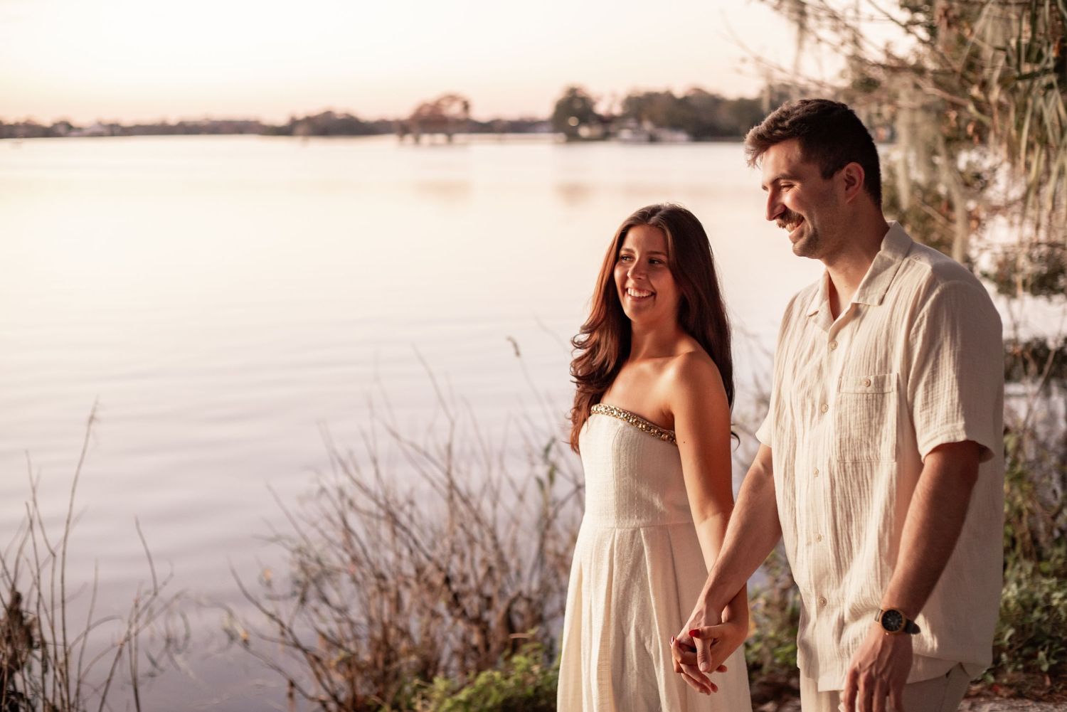 Engagement photos of a couple walking through Kraft Azalea Garden in Winter Park.