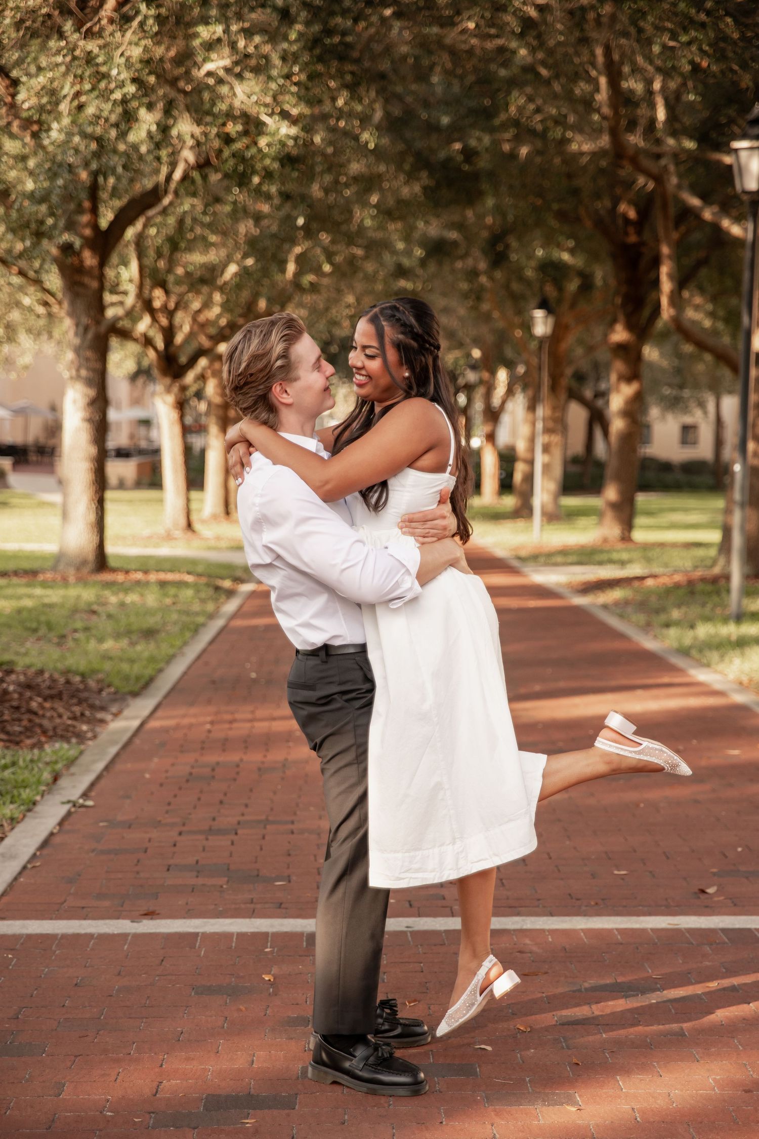 Engaged couple embracing on the Rollins College campus in Winter Park, Florida.