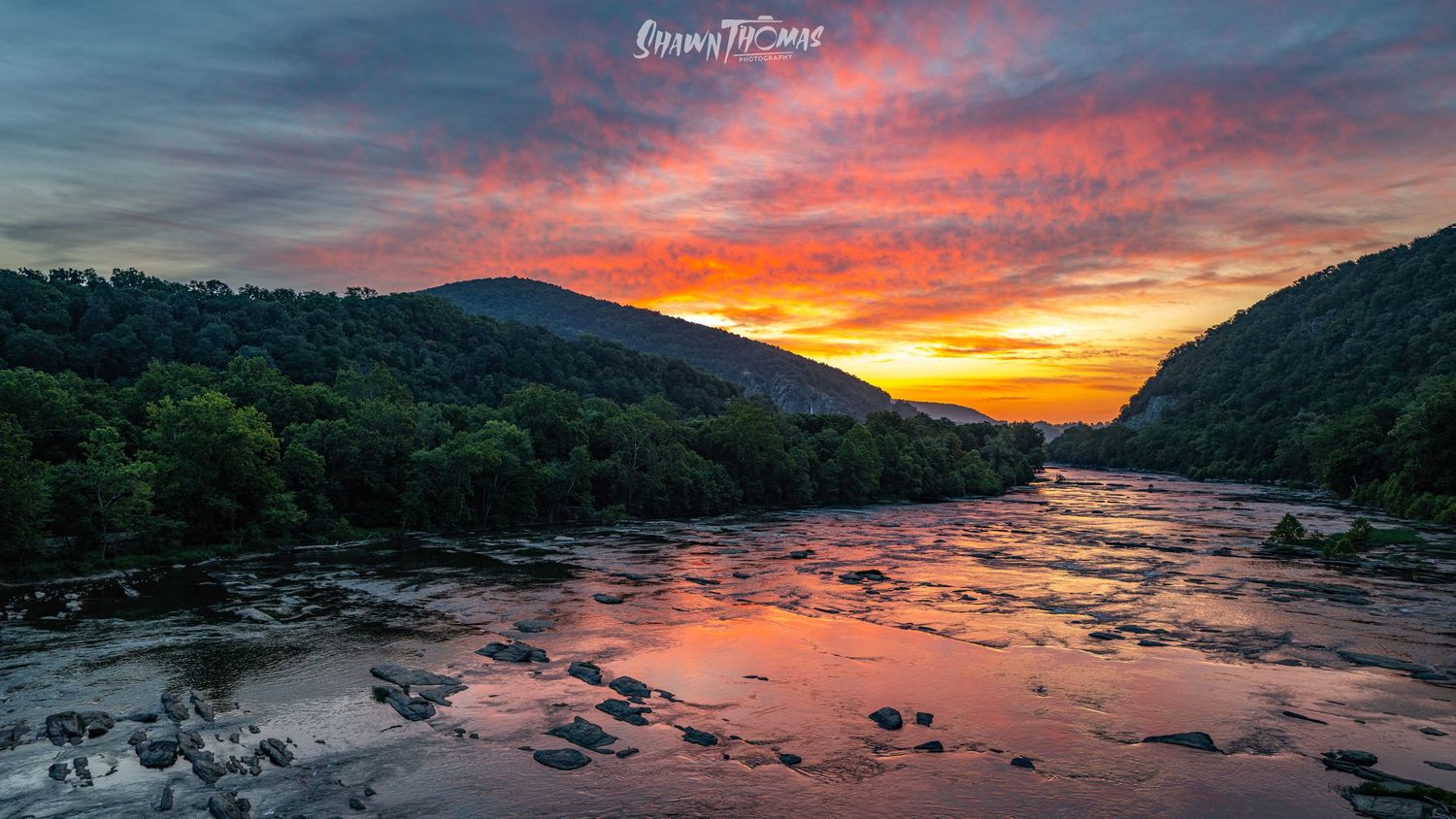 Fiery sunset reflects off the Potomac and Shenandoah rivers at Harpers Ferry, West Virginia.