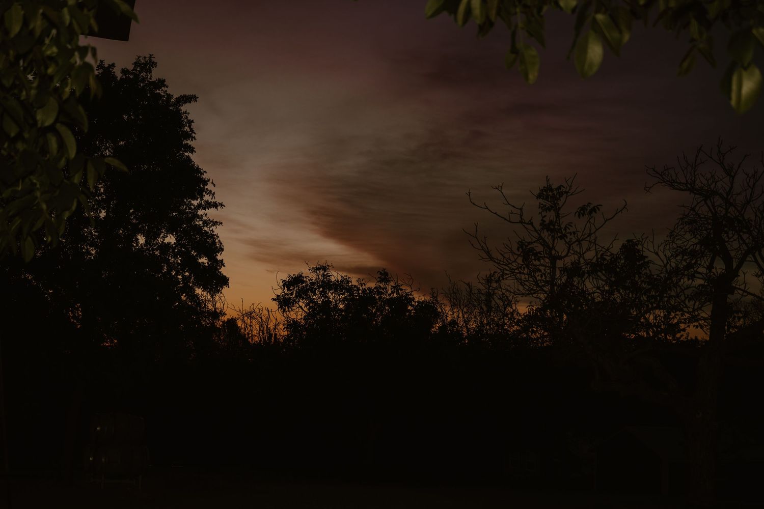 Sunset sky with dramatic clouds over outdoor wedding venue.