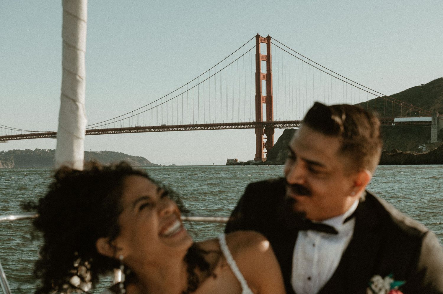 A romantic boat ride near the Golden Gate Bridge at sunset.
