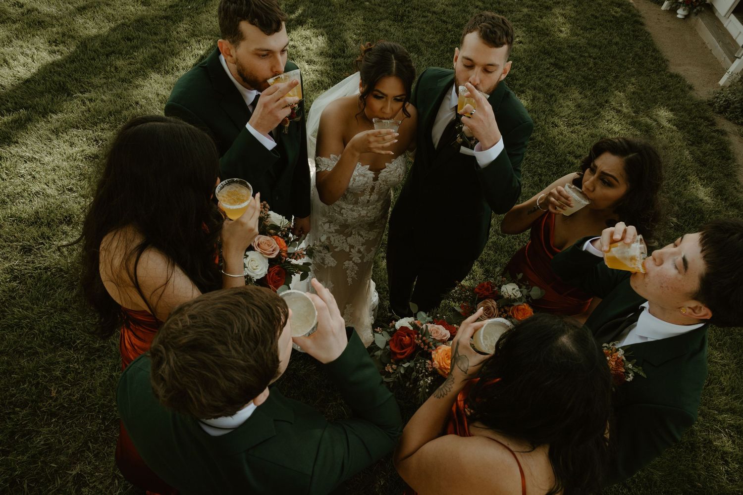 Wedding party laughing and celebrating together during outdoor cocktail hour.