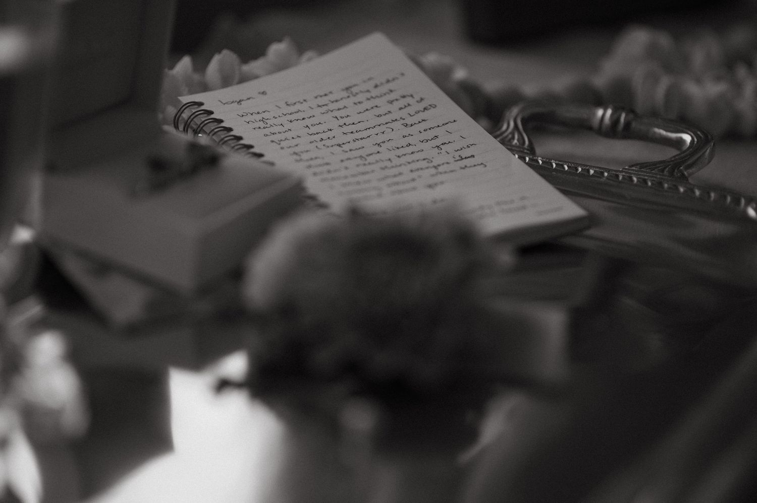 Close-up shot of handwritten wedding vows on paper with soft focus.