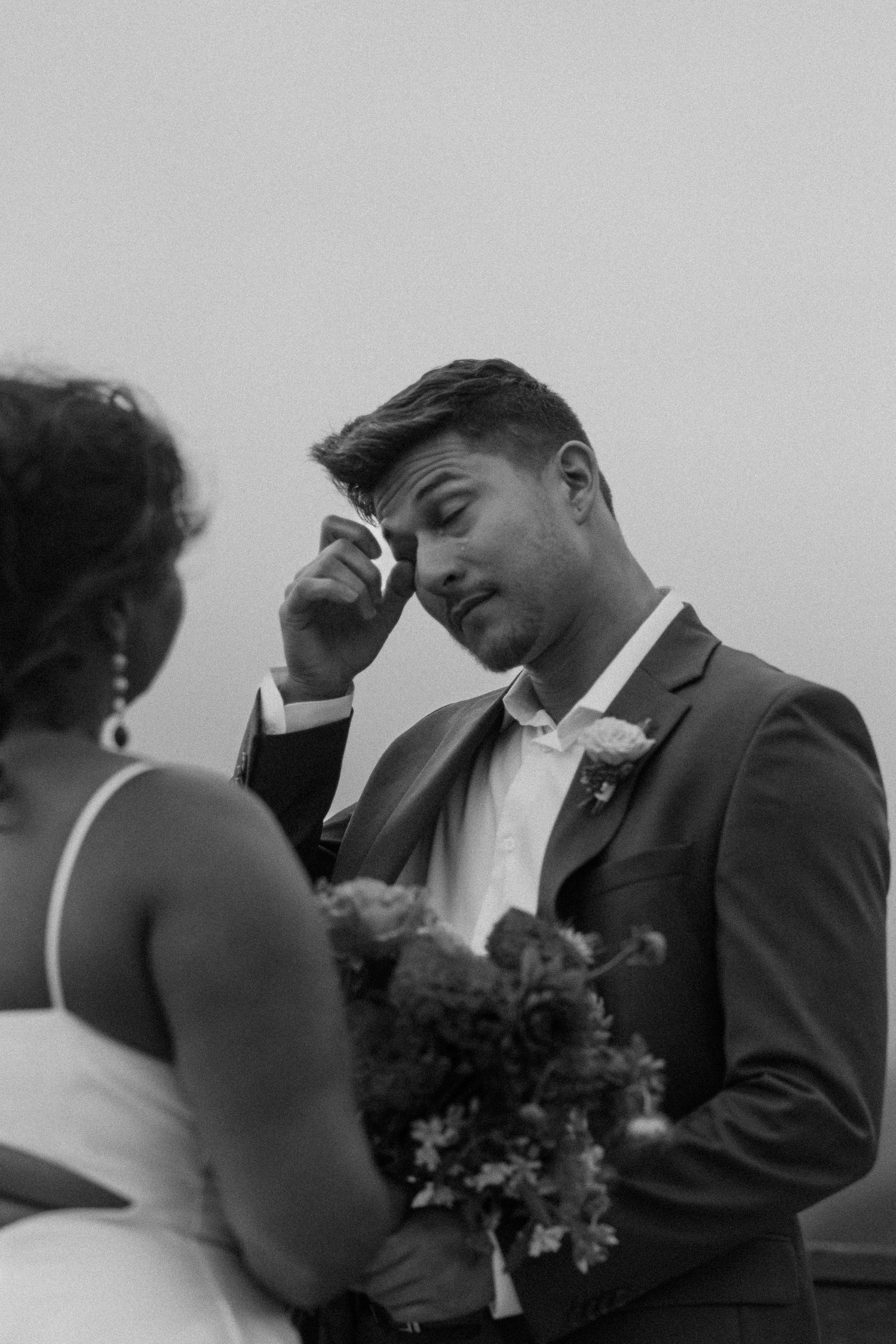 Emotional black and white wedding moment captured in natural light.