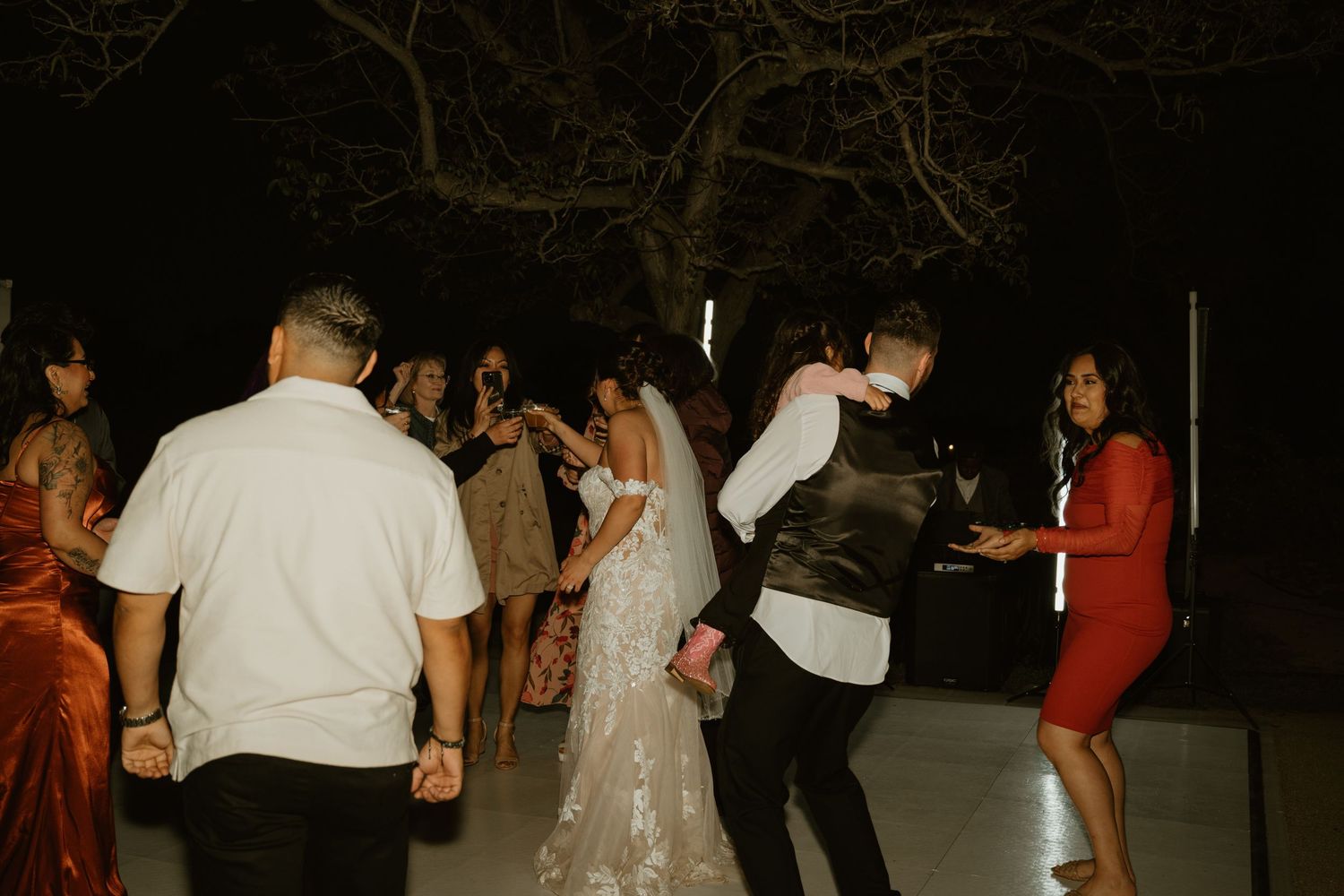 Wedding reception dance party with guests enjoying the evening celebration.