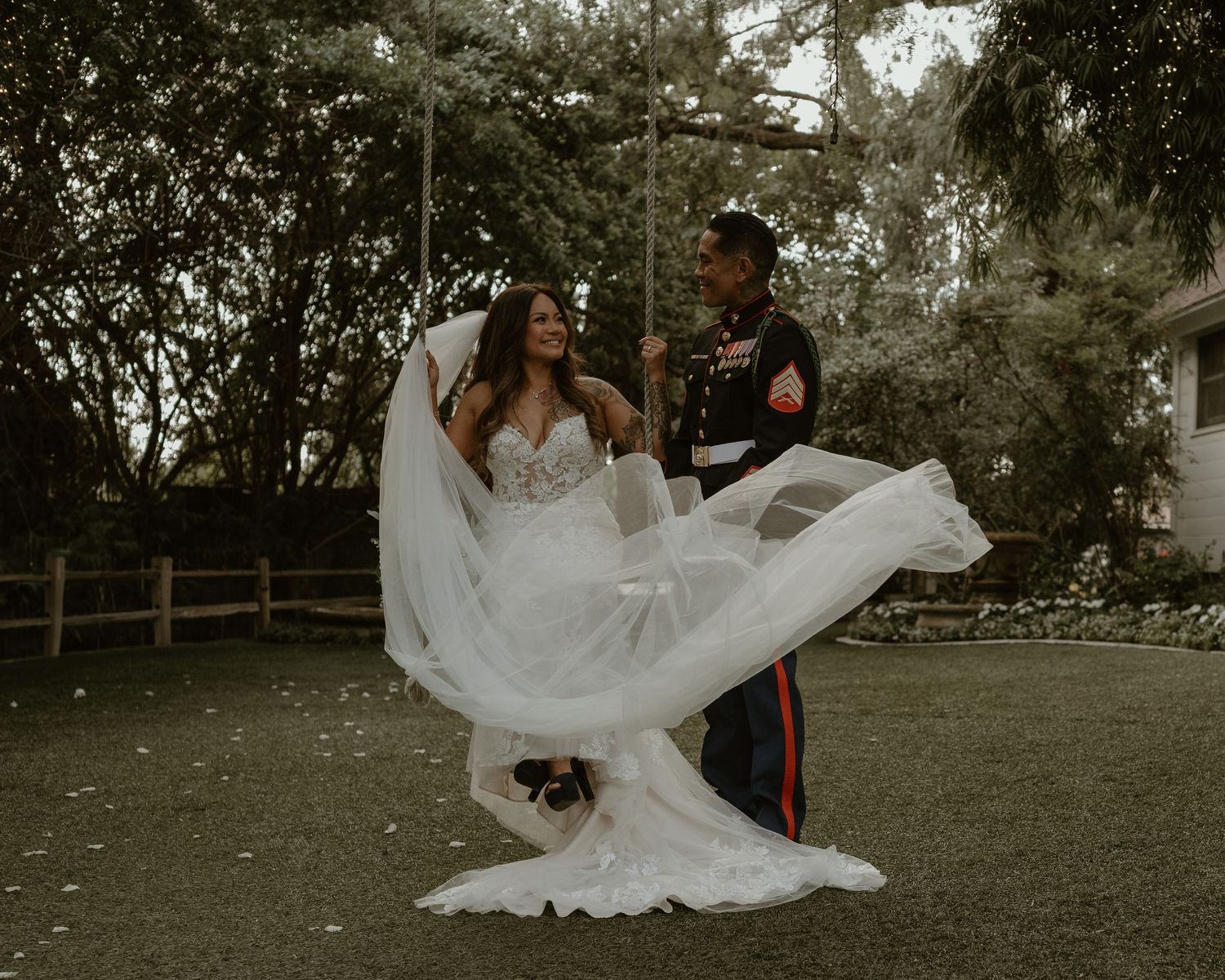 Flowing white wedding dress fabric catches the wind during an outdoor photoshoot.