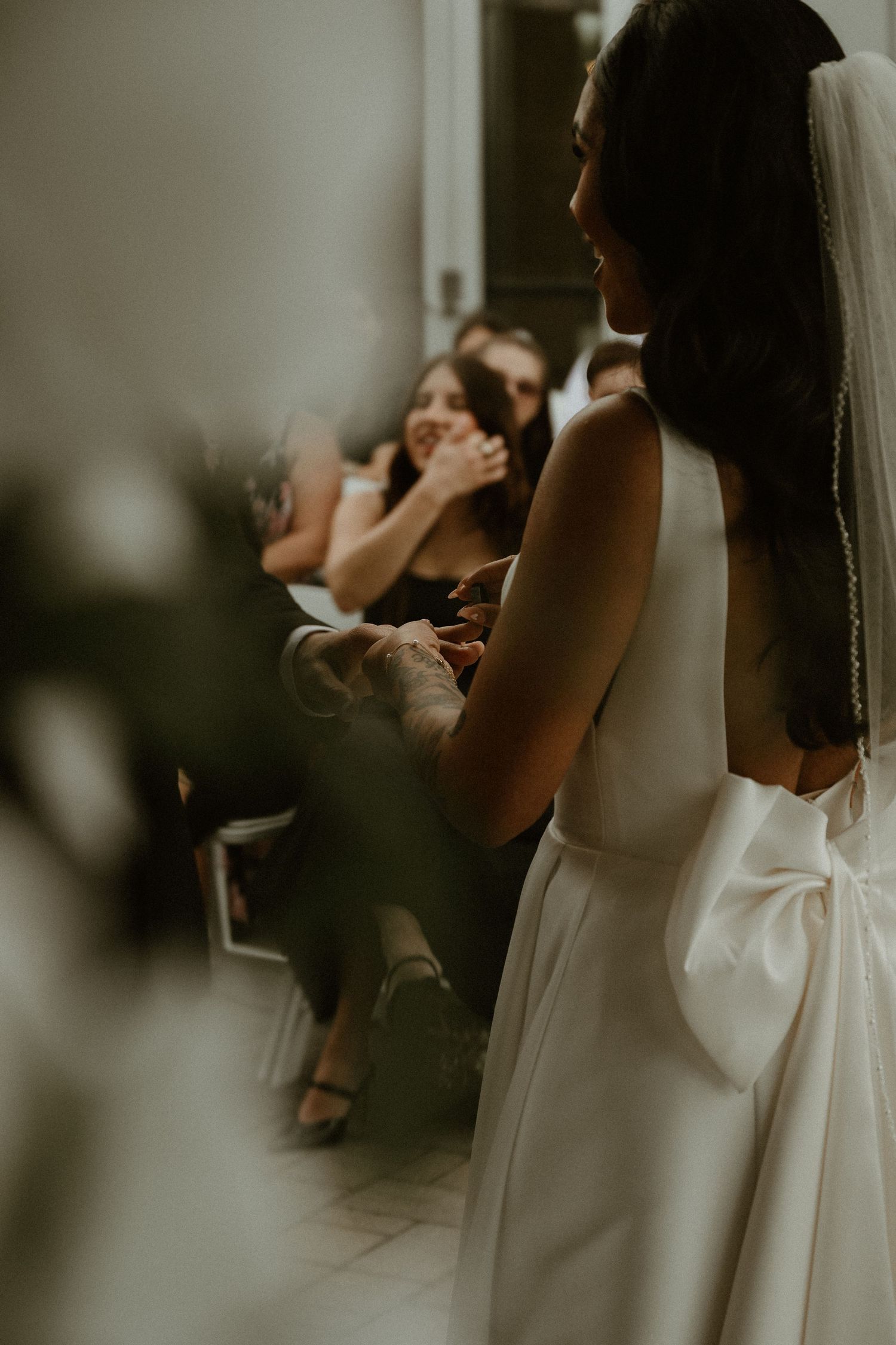 An elegant white wedding dress with a dramatic bow detail captured from behind.