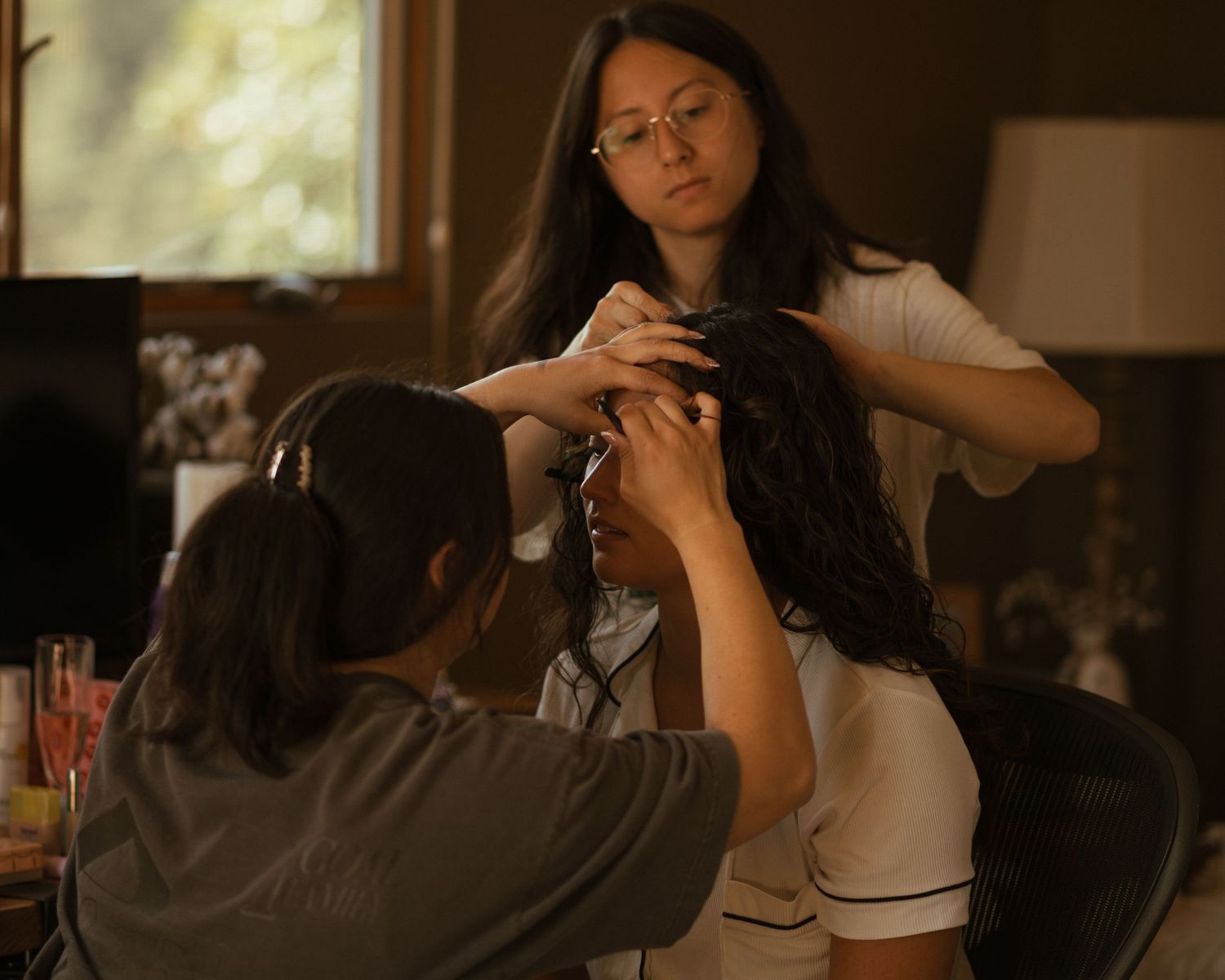 Wedding preparation scene in warm indoor lighting with flowing white dress.