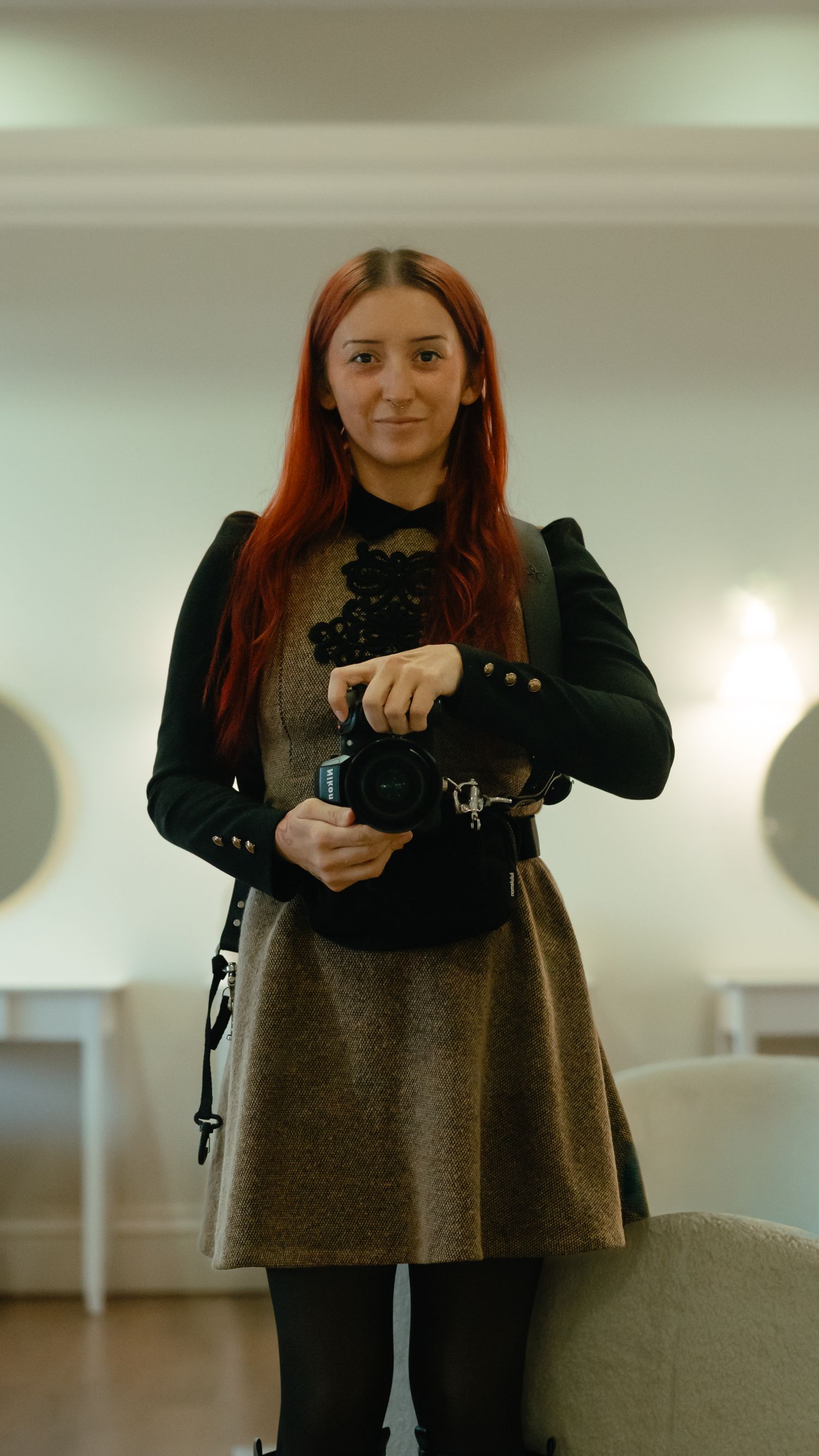A person in a gray sweater and black scarf takes a series of mirror selfies showing different poses and angles.