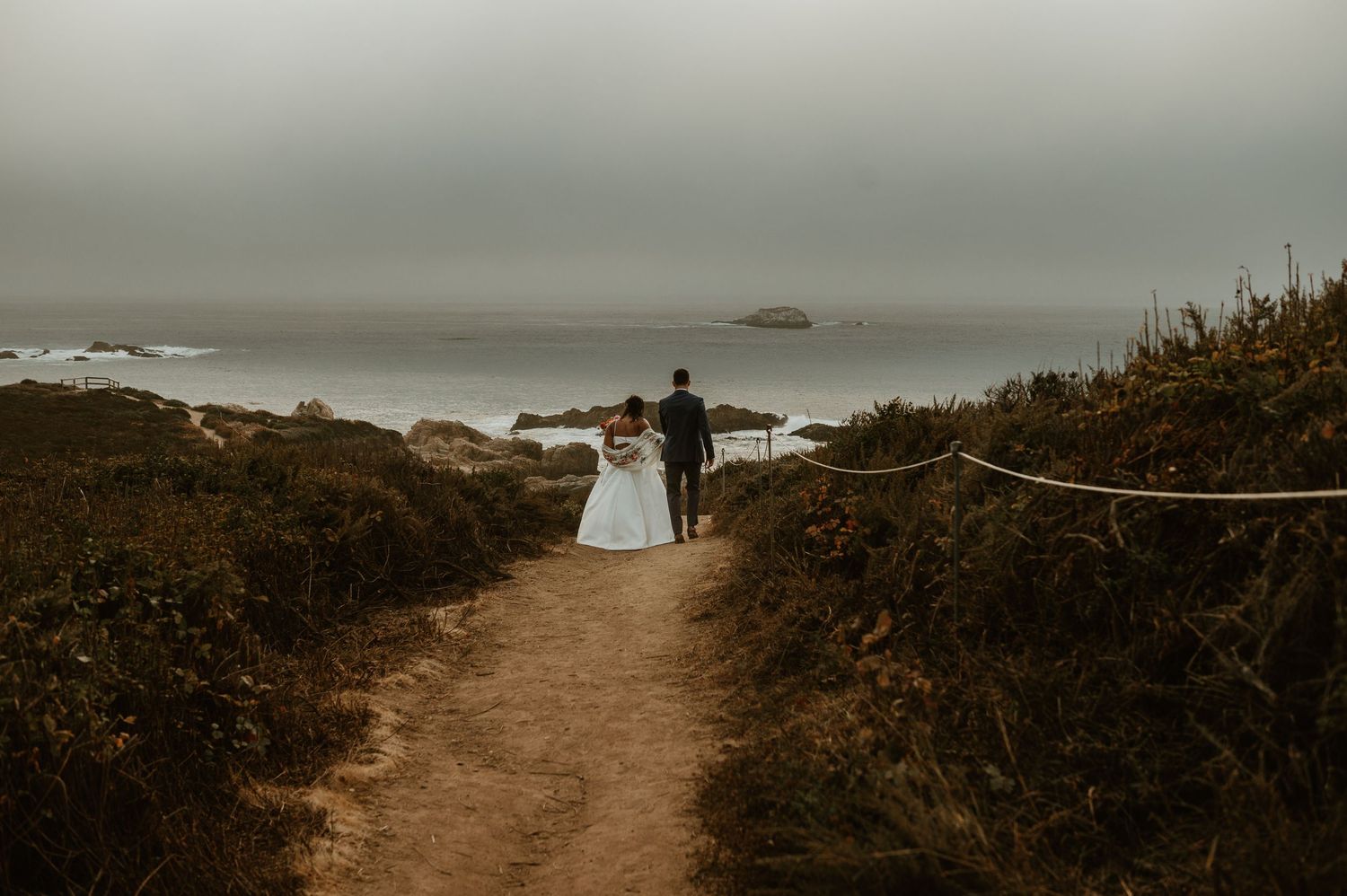 Coastal trail overlooking ocean cliffs and misty horizons.