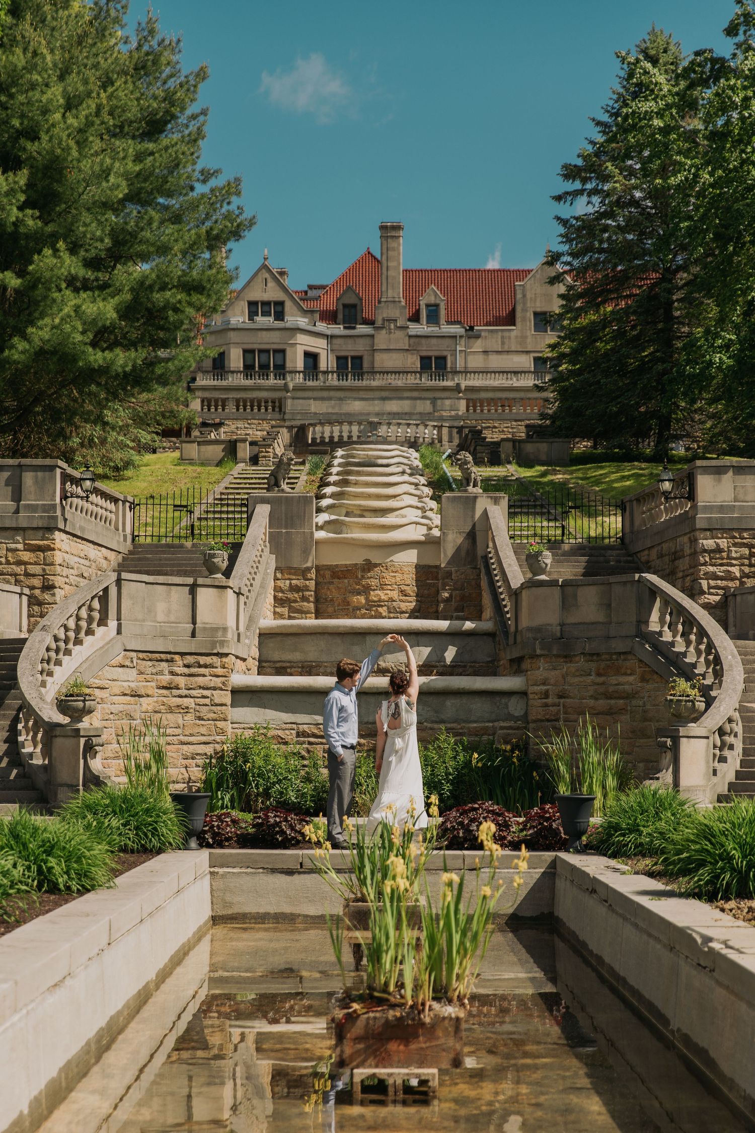 Elegant stone staircase and terraced garden at a historic mansion venue.
