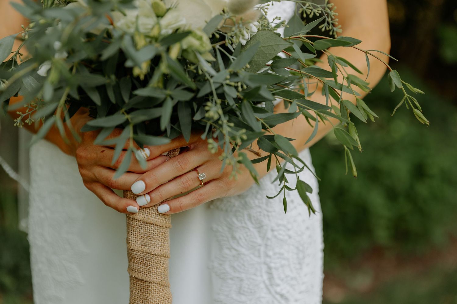 A close-up of bridal hands holding a rustic bouquet wrapped in twine in Central Pennsylvania