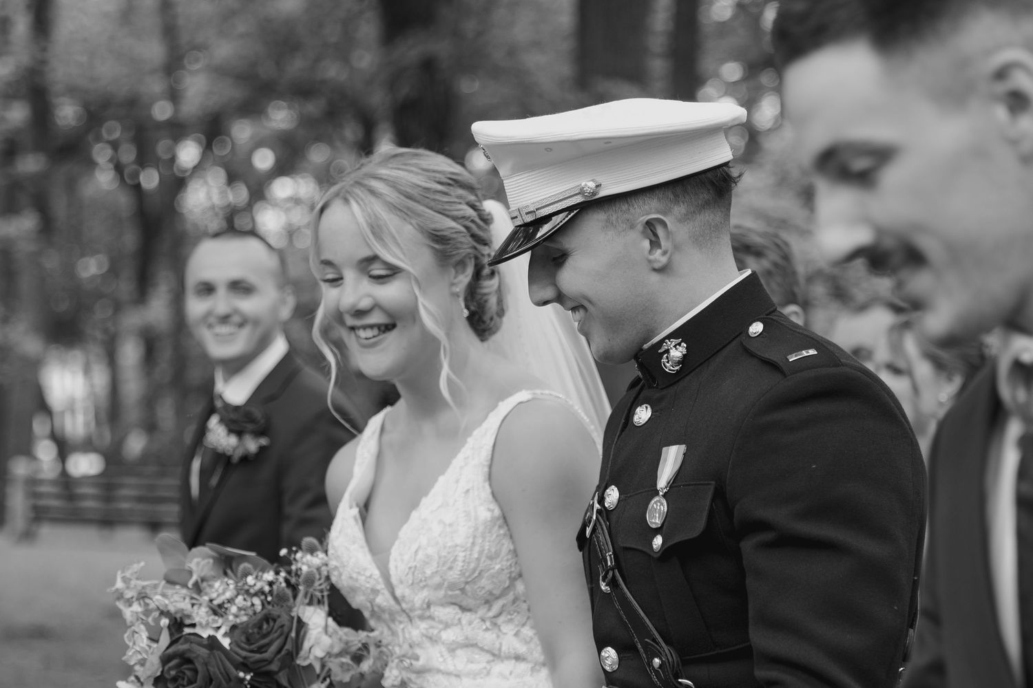 Black and white photo of a military wedding ceremony with classic formal attire.