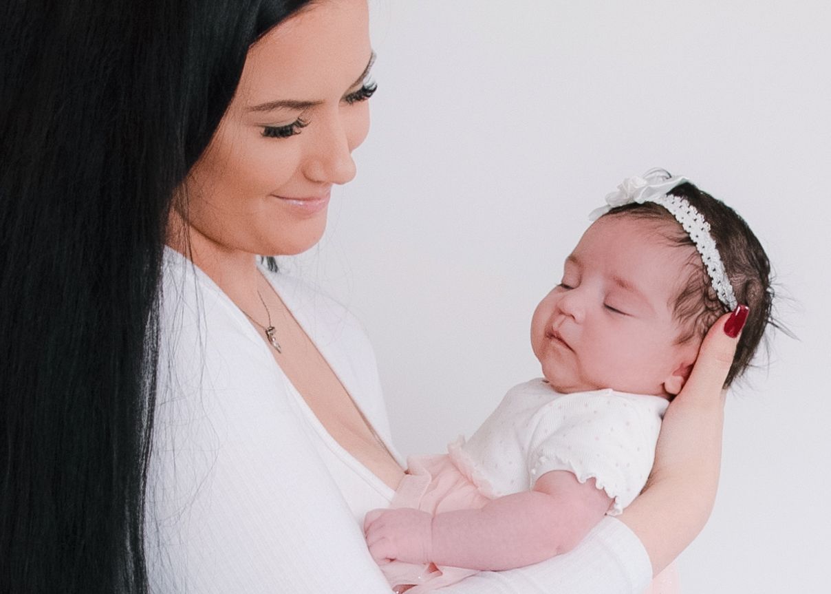 Series of tender moments between caregiver and newborn baby in studio setting.