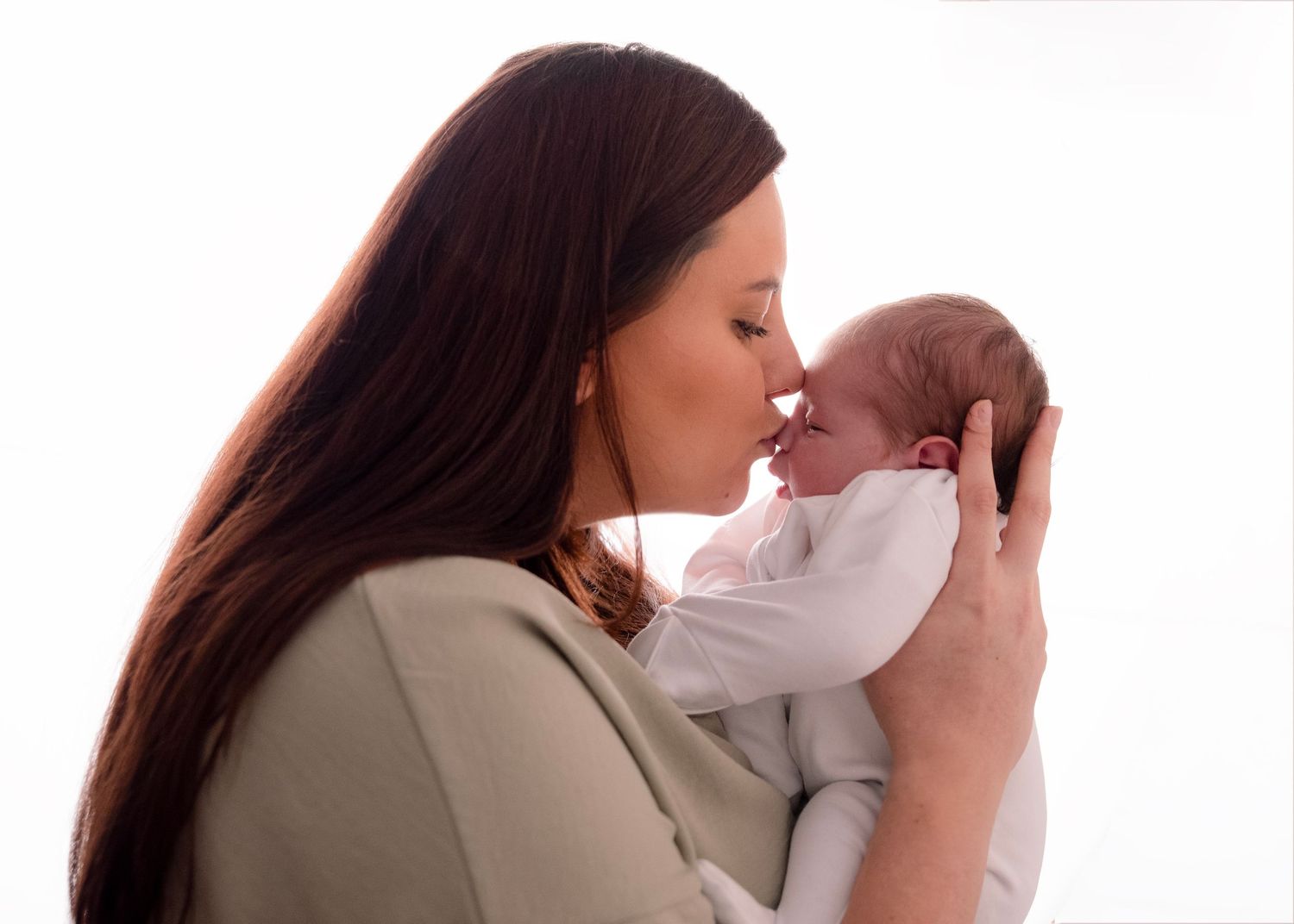 Series showing parent bonding with newborn in intimate poses.