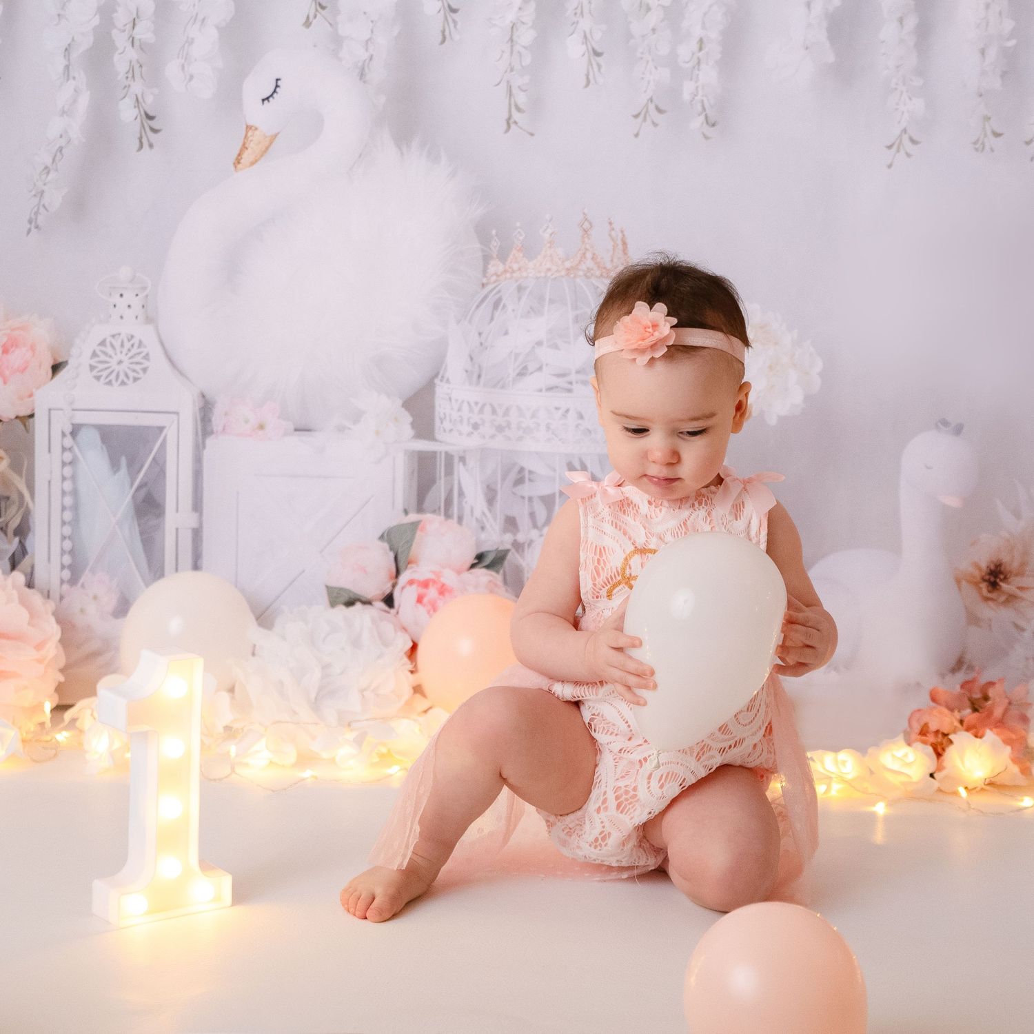 Baby milestone photos with twinkling lights and romantic decor.