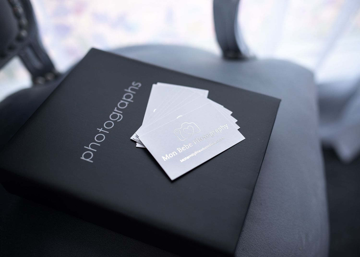 Close-up of black business card mockups on dark background.