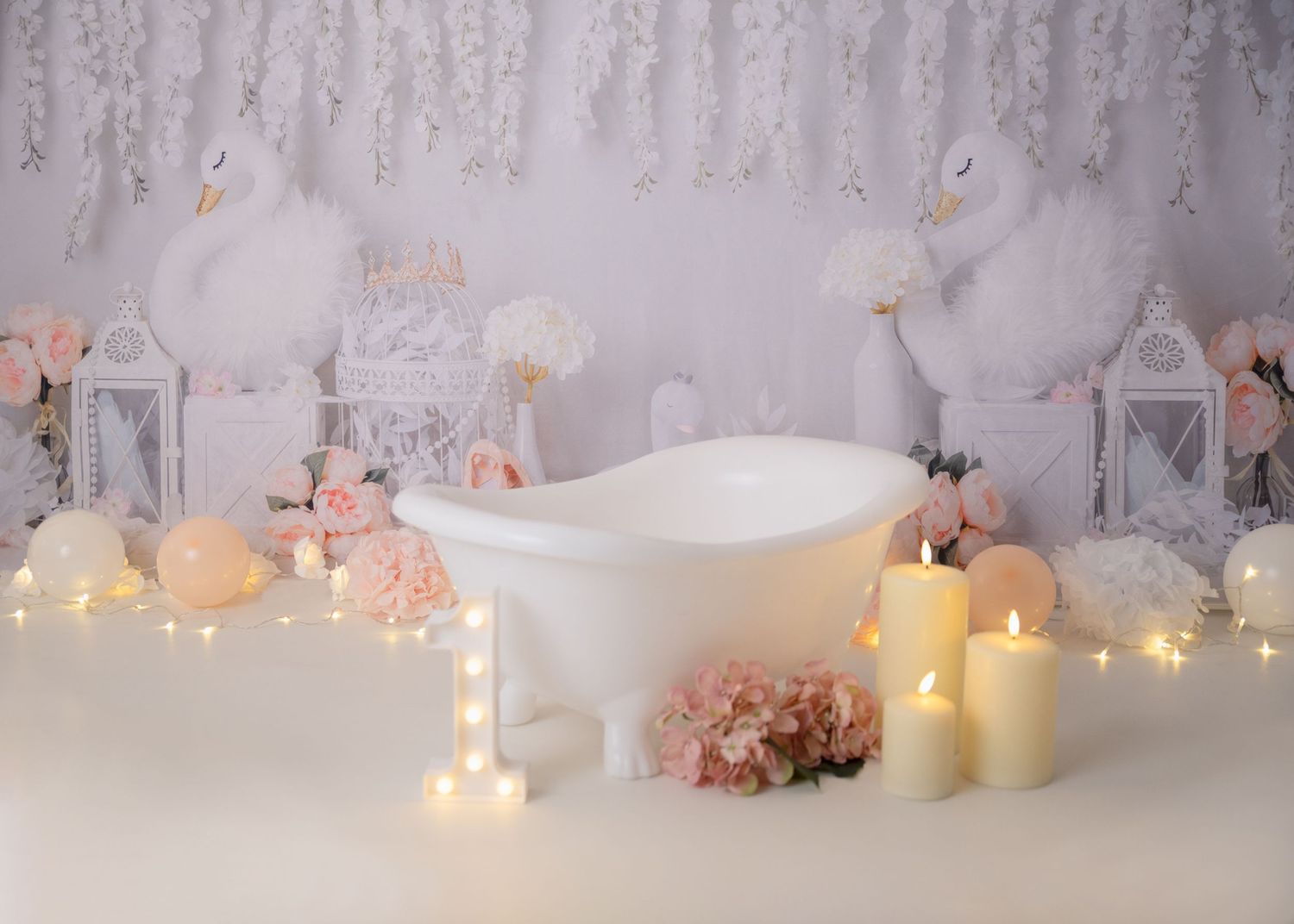 Elegant white backdrop with hanging crystals and glowing candles creating a dreamy atmosphere.