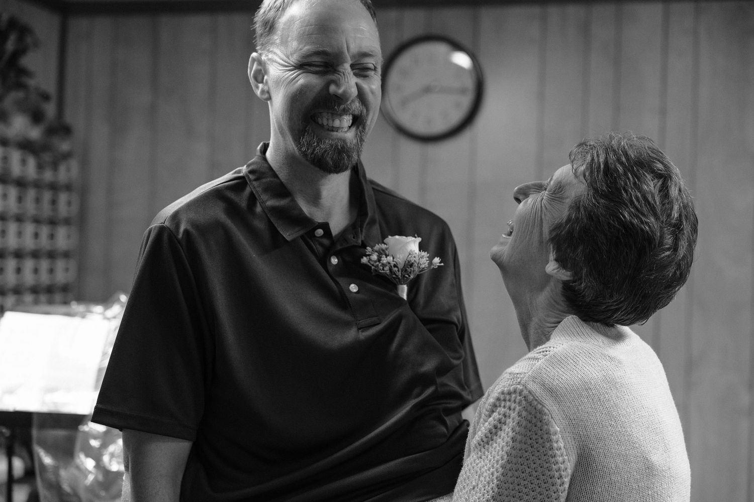 Black and white candid moment captured during a wedding celebration.