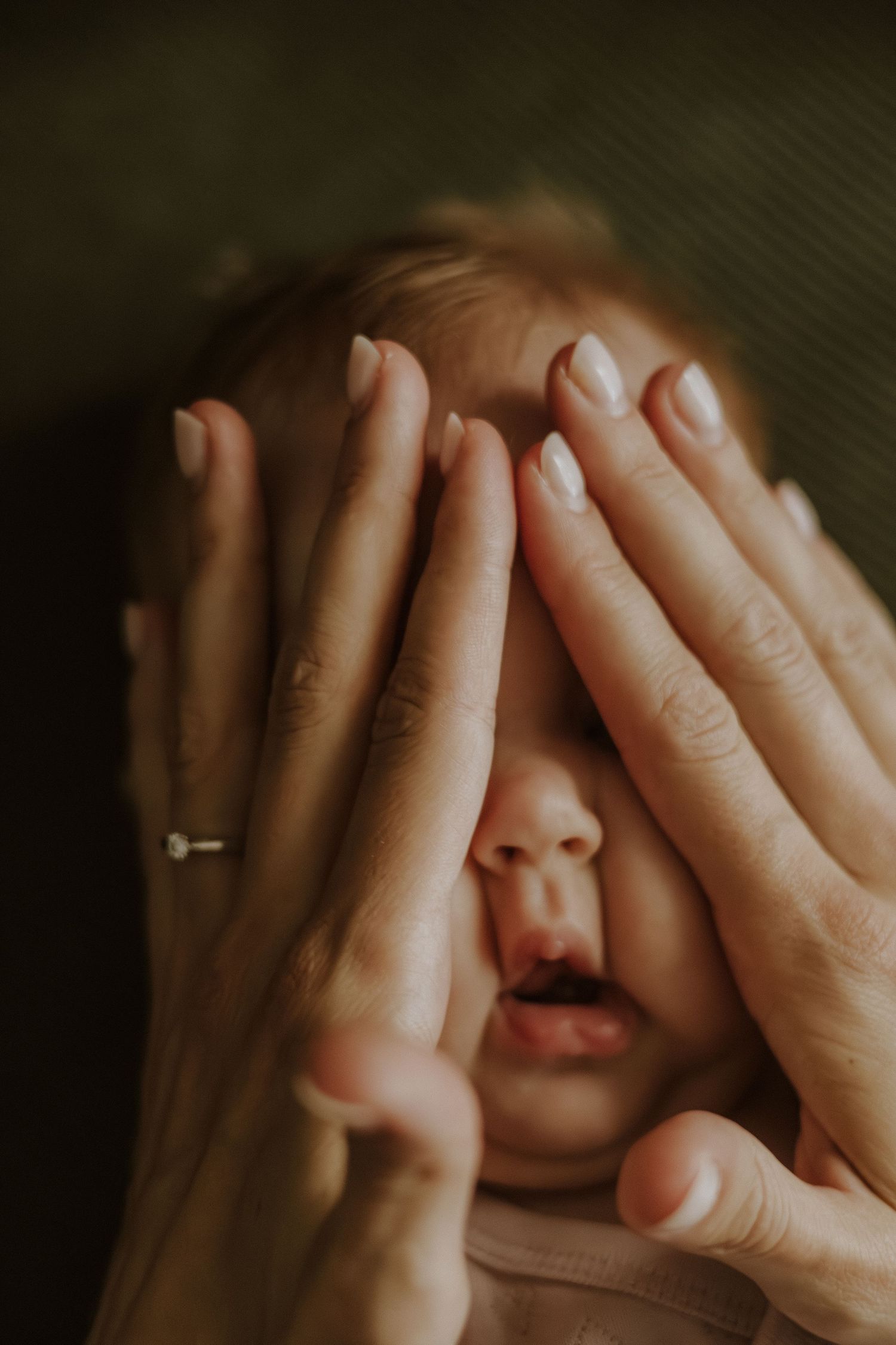 A sequence of hands covering eyes in different positions against a dark background creates a cinematic visual effect.