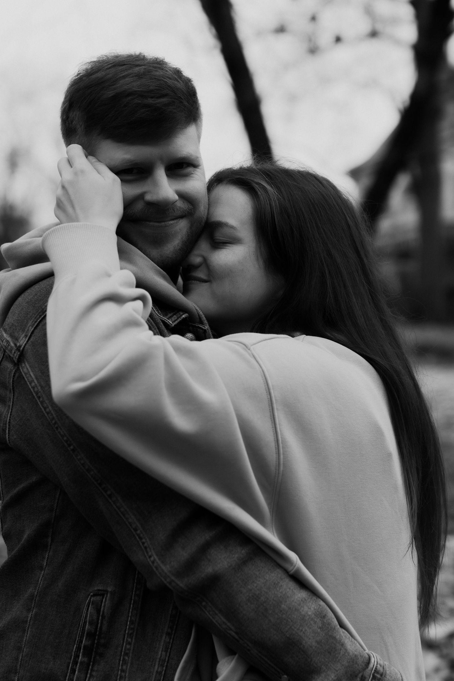 A couple embraces tenderly in a black and white photo series showing intimate moments between them.