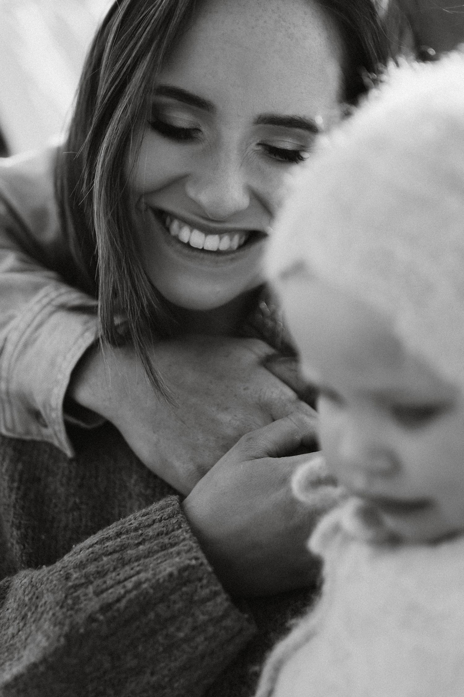 A series of intimate black and white photos showing tender moments between parent and child in soft lighting.