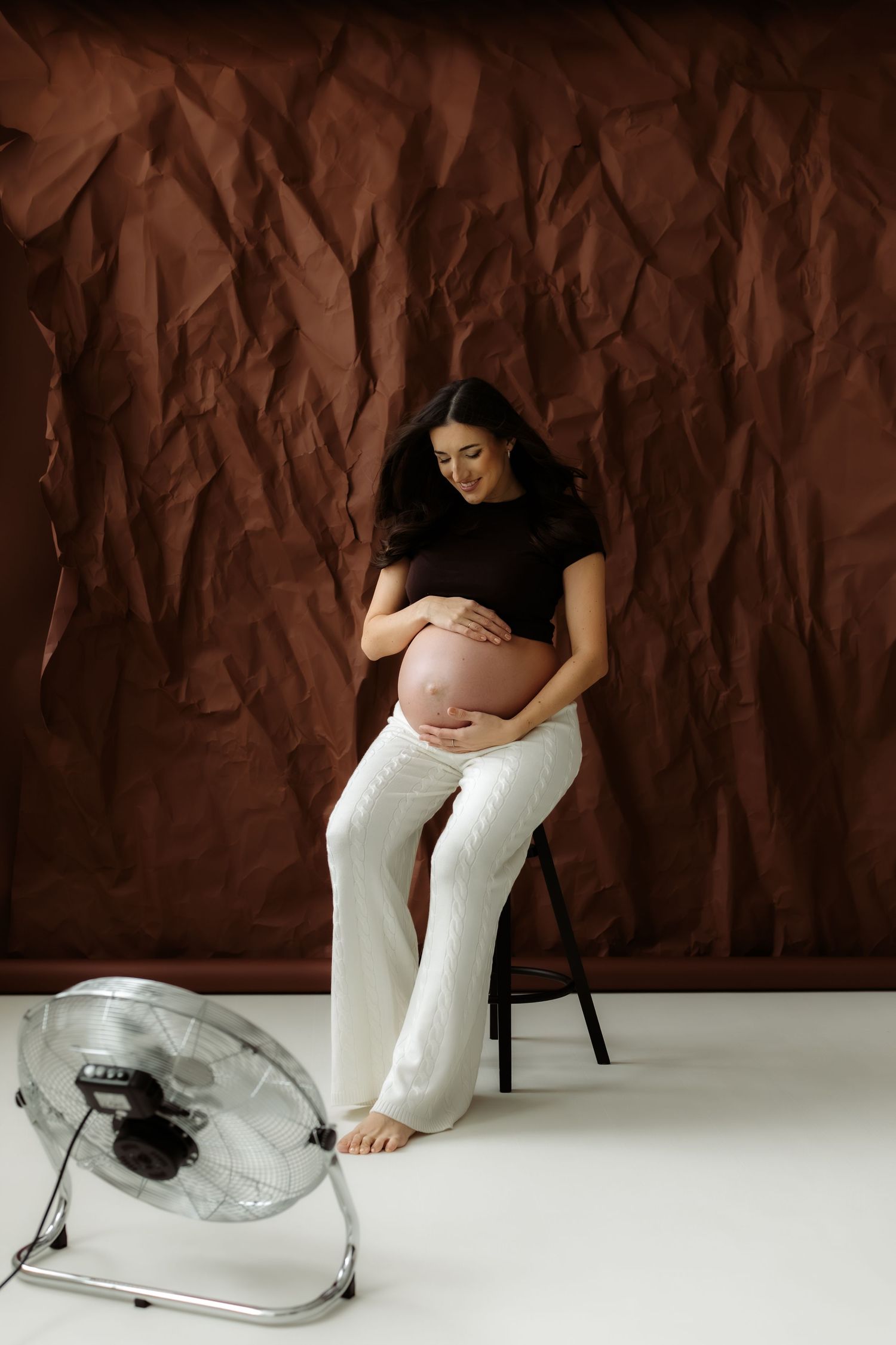 A sequence showing someone placing their foot into a clear plastic shoe against a brown textured backdrop.