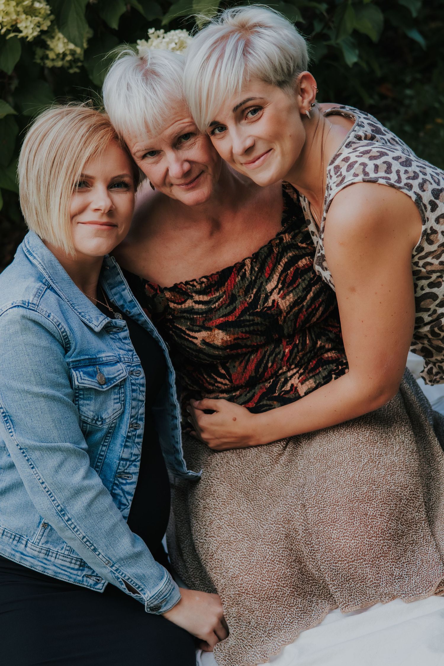 A series of intimate outdoor portrait photographs showing tender embraces and affectionate moments in natural lighting.
