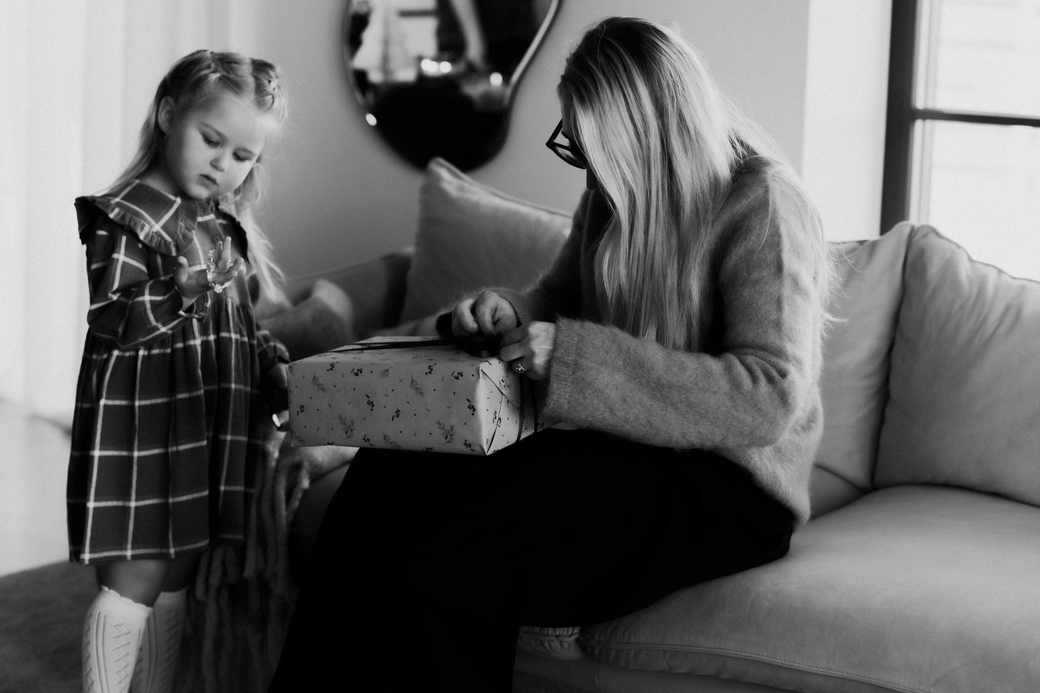 Black and white photo series showing a person sitting in different positions on a couch.