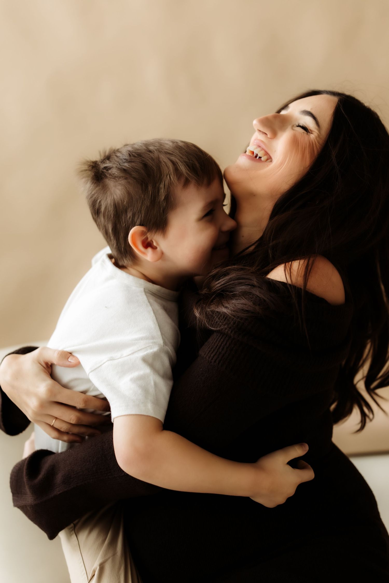 A heartwarming series of candid moments showing a parent and child embracing and laughing together.