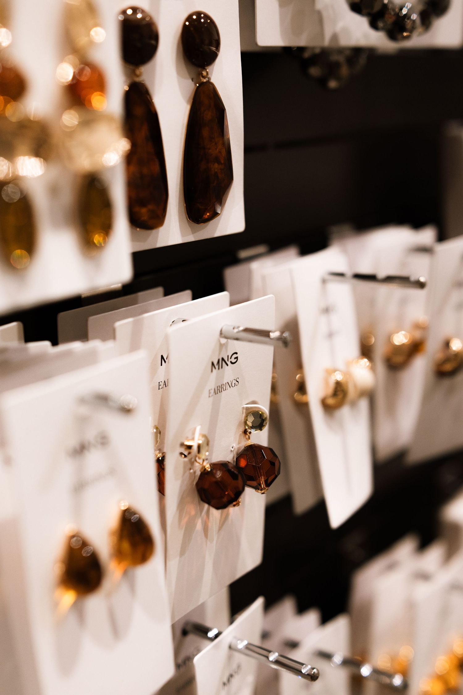 Close-up view of wax seals and name cards arranged on display hooks against a white background.