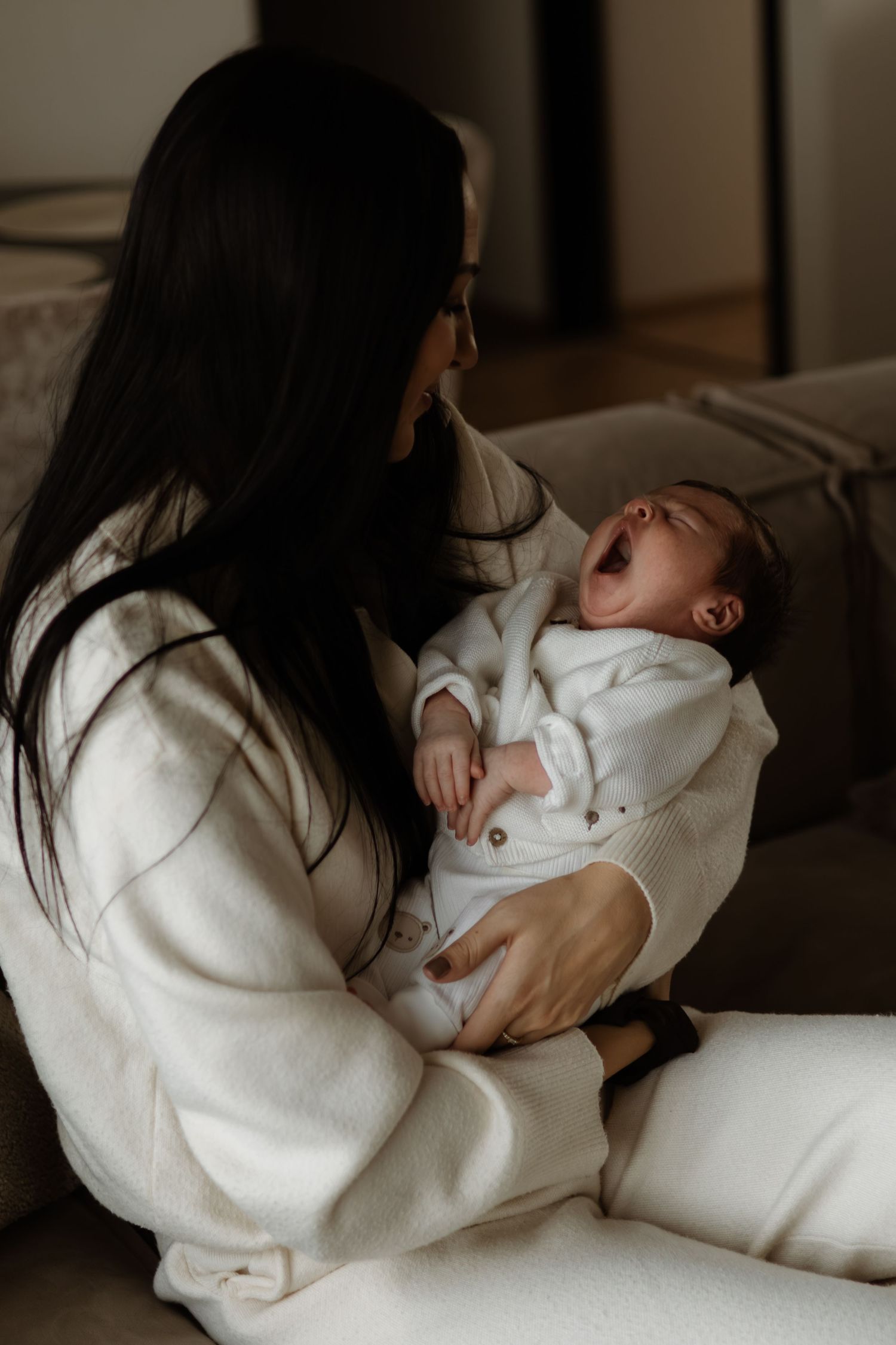 A tender moment captured in a series of photos showing a parent cradling and bonding with their newborn baby.