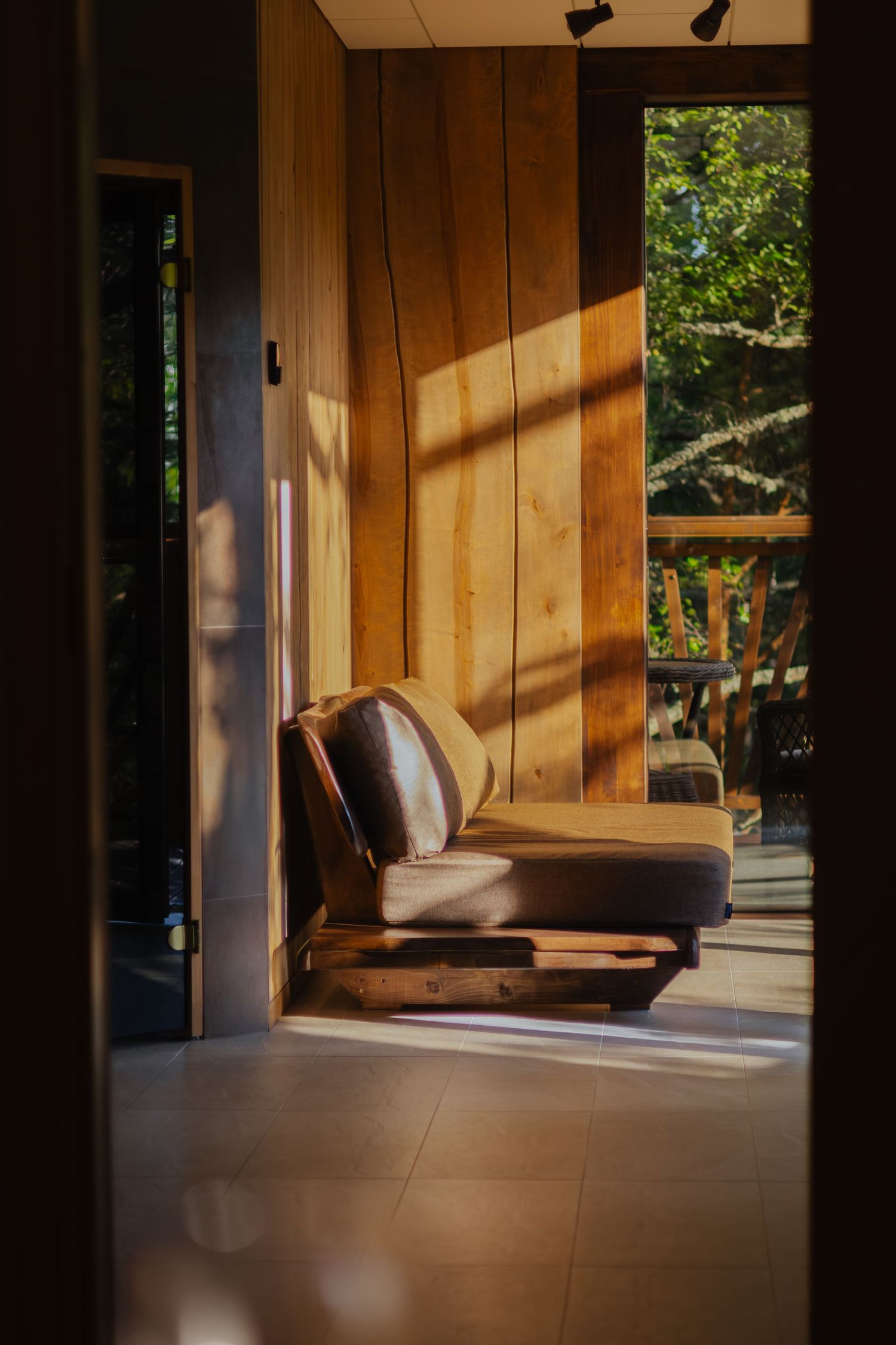 Sequence of images showing diagonal sunlight creating dramatic shadows on wooden walls and furniture in a modern room.