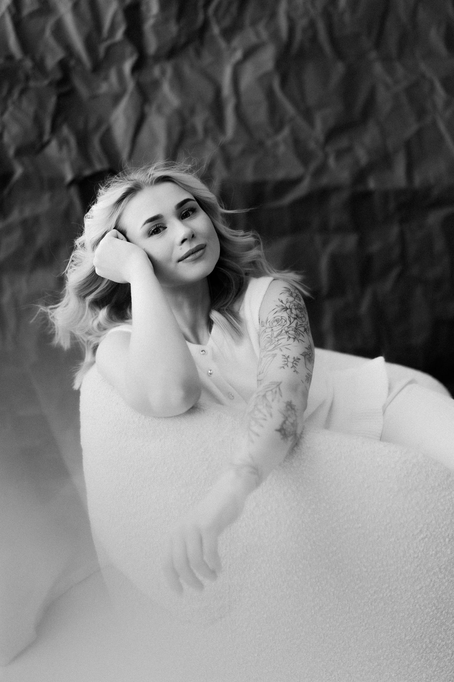 A black and white portrait series showing dreamy bath scenes with bubbles and artistic composition.