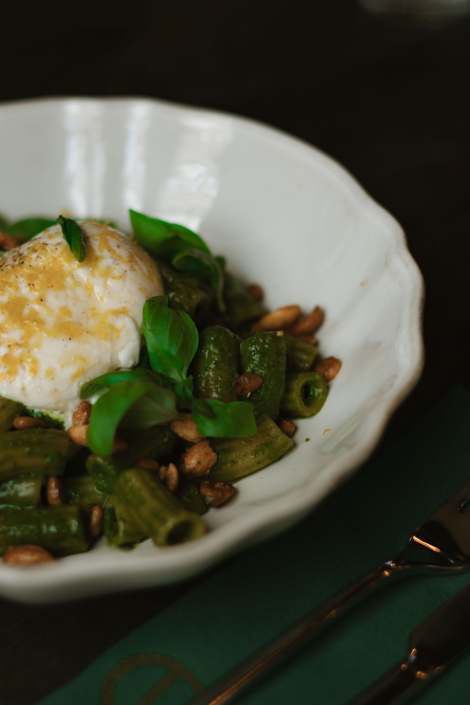 Three artistic food photos showing asparagus spears and poached eggs on white plates with dark moody lighting.