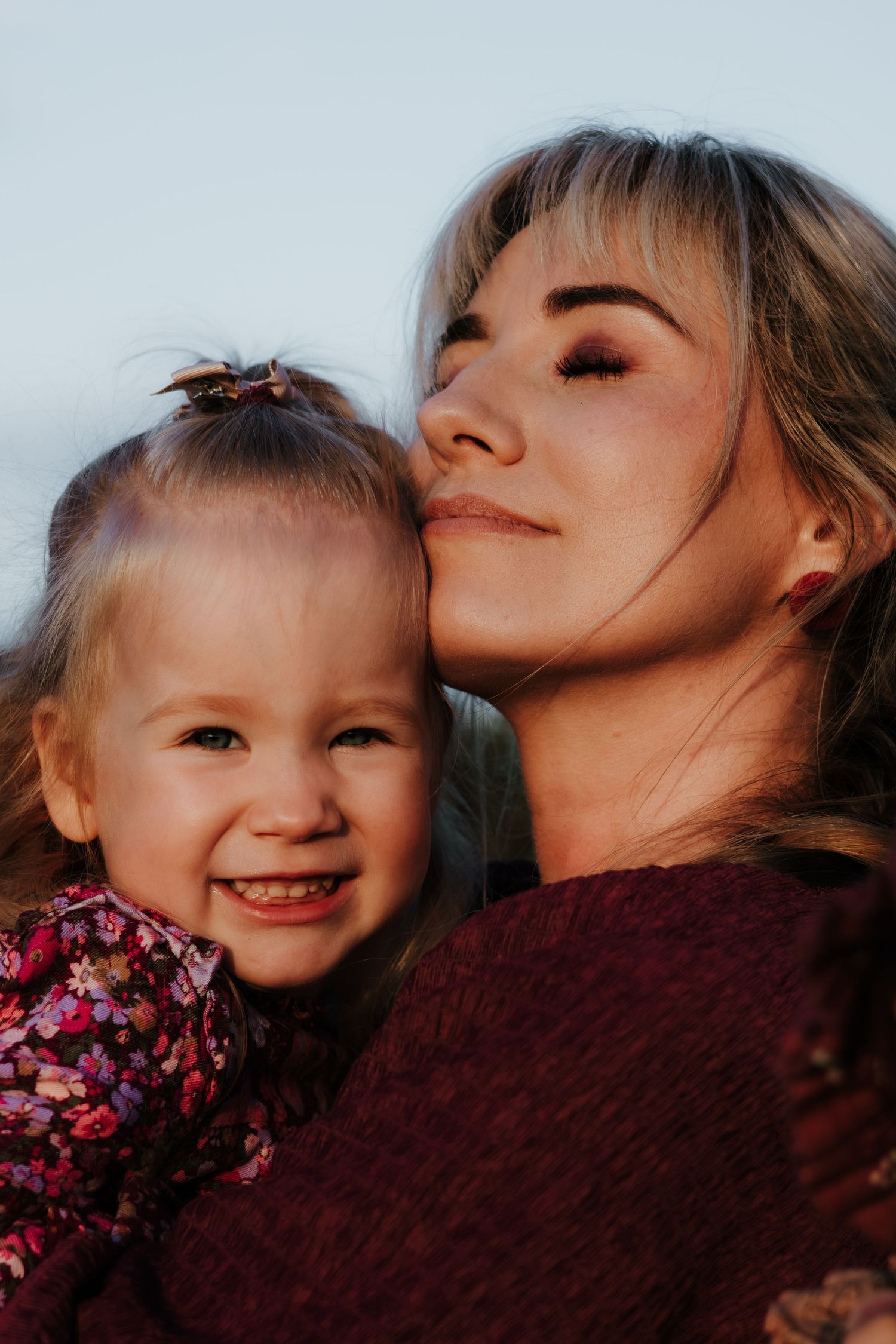 A series of intimate photos showing tender moments between parent and child against a soft light background.