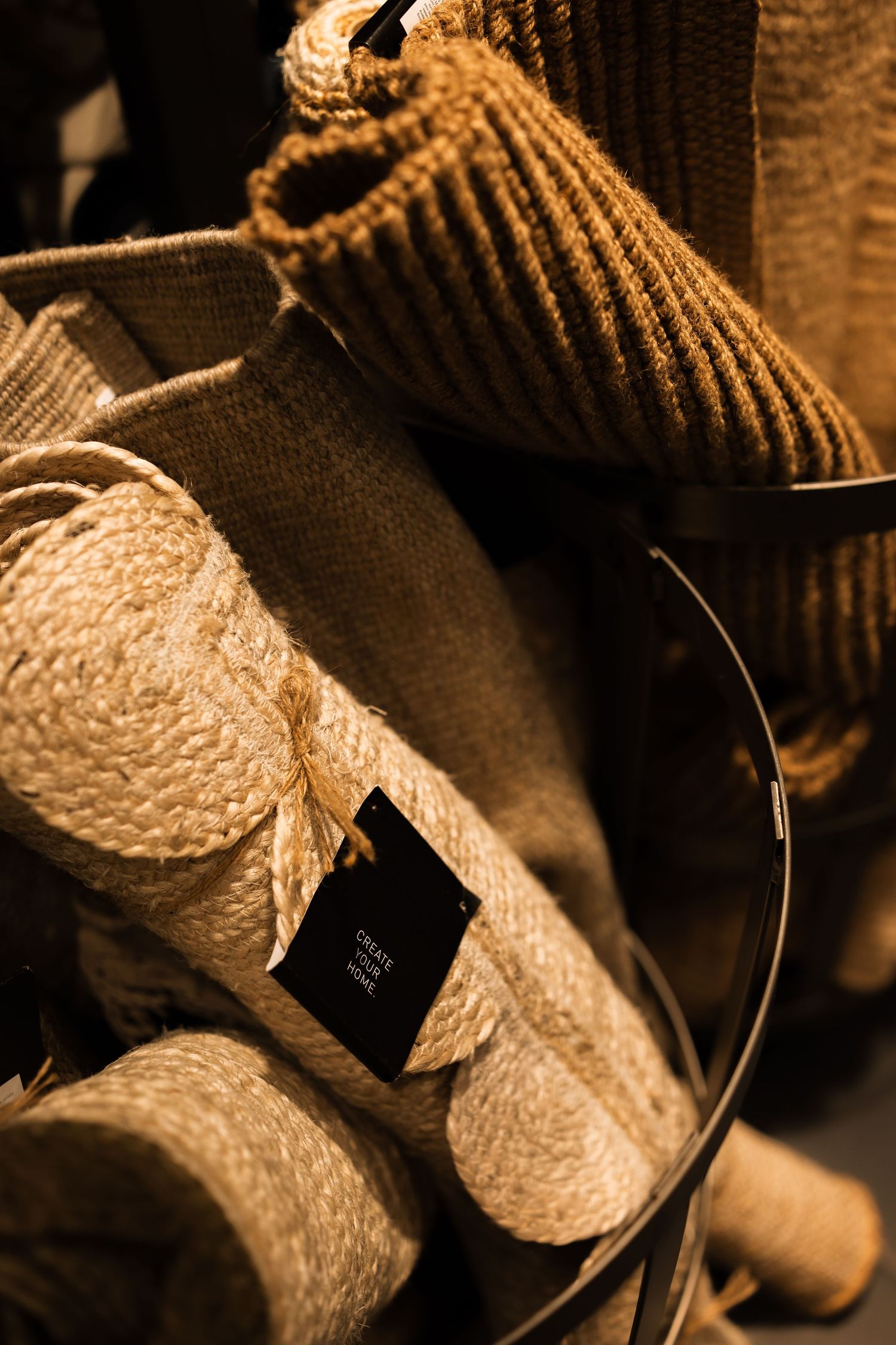 Close-up sepia-toned images showing details of knitted or woven textiles with contrasting textures and patterns.