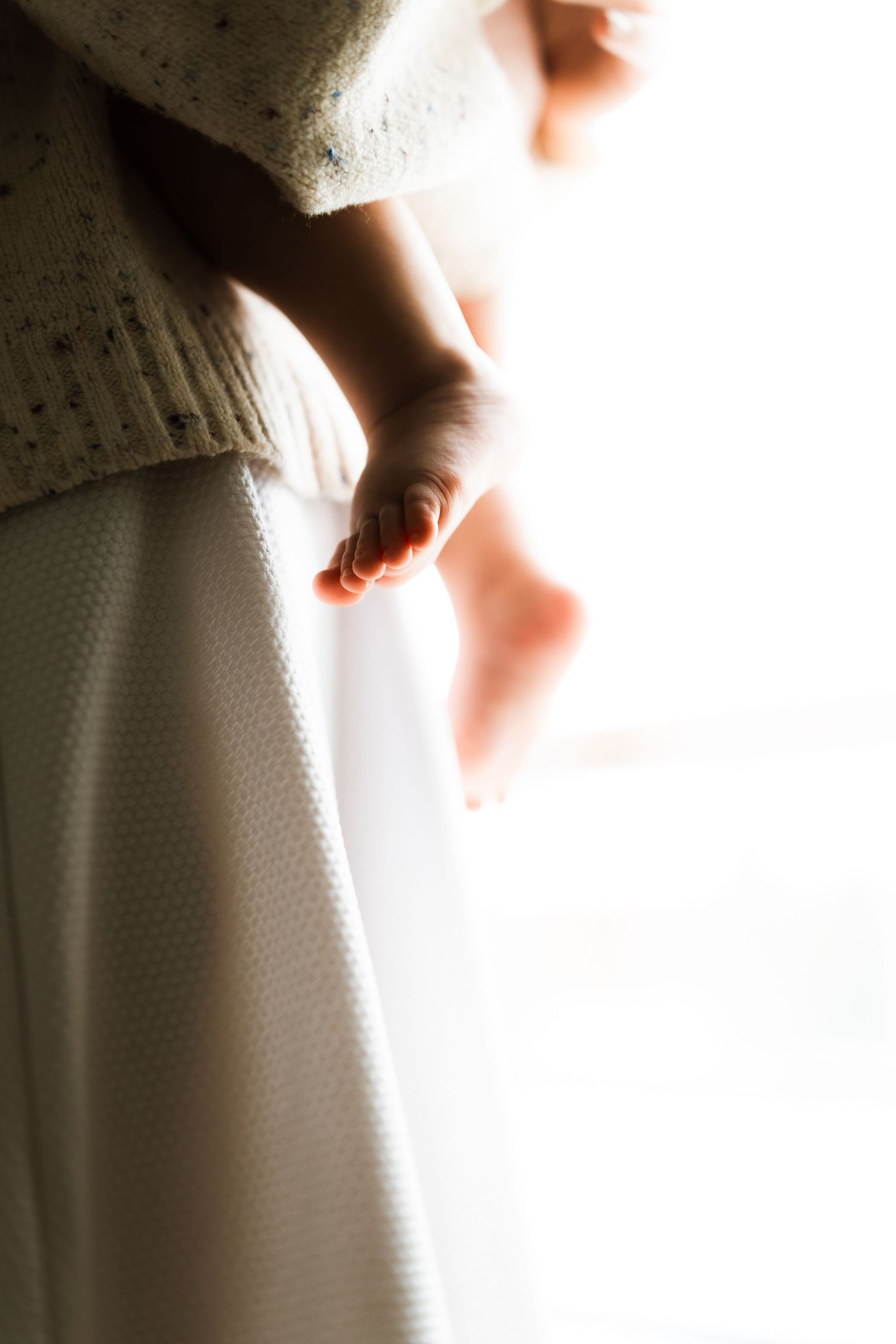 A series of soft focus images showing small feet and toes against a white background.