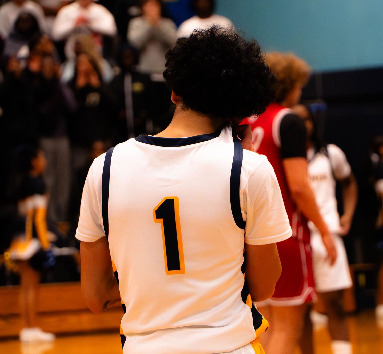 Mariner High School basketball player wearing jersey number 1 stands on court during a game.