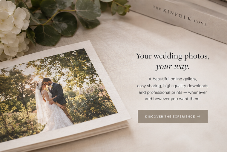 Elegant wedding photo album open on a marble surface with hydrangeas, promoting an online wedding photo gallery service.