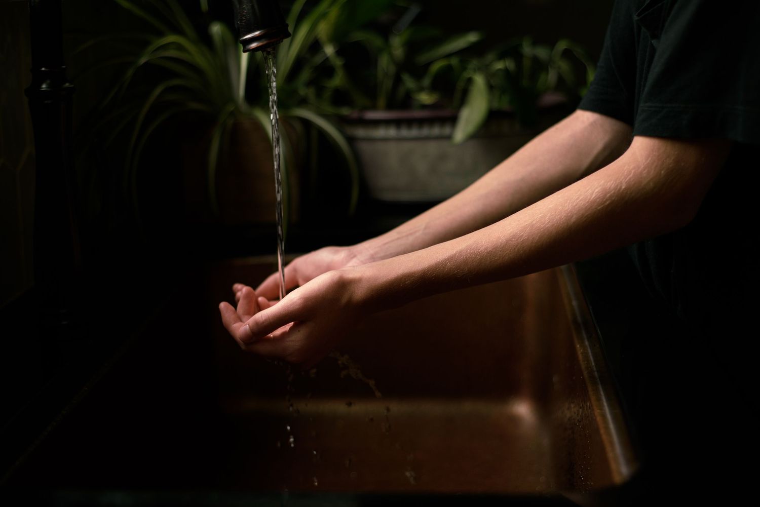 Hands at a sink with running water. Tracey Richvalsky, Rhythm In Light Photography