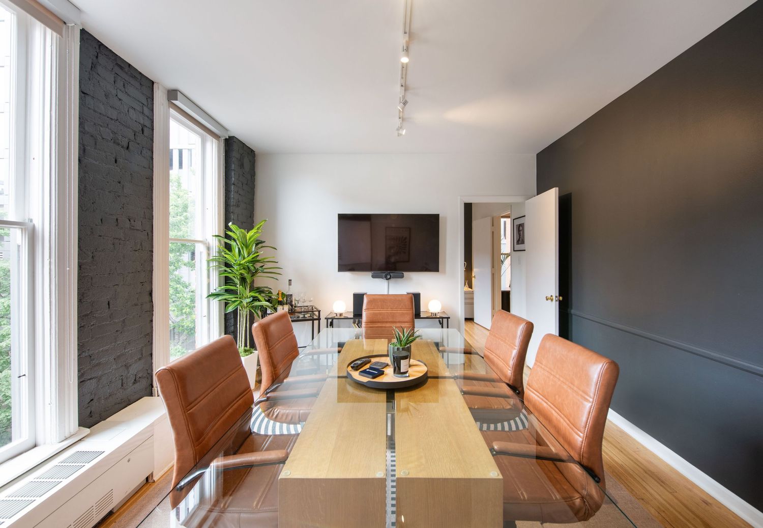 Open concept office space with wooden conference table and natural lighting.