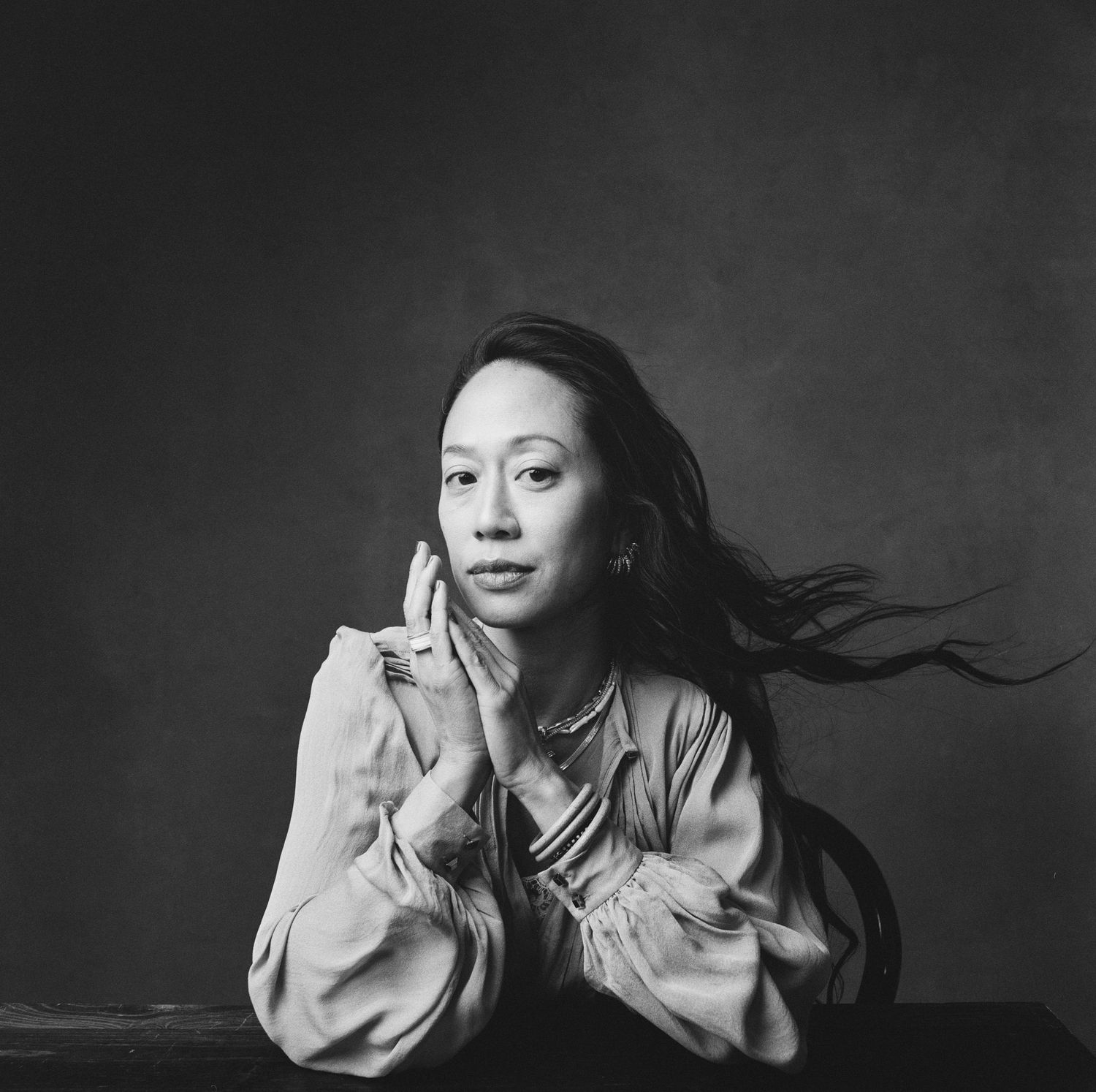 Black and white portrait series showing dynamic movement and flowing hair against a dark background.